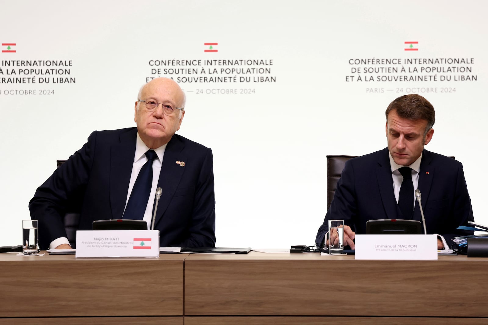 France's President Emmanuel Macron and to Lebanon's Prime Minister caretaker Prime Minister Najib Mikati, left, attend an international conference for Lebanon in Paris, Thursday, Oct.24, 2024. (Alain Jocard, Pool via AP)