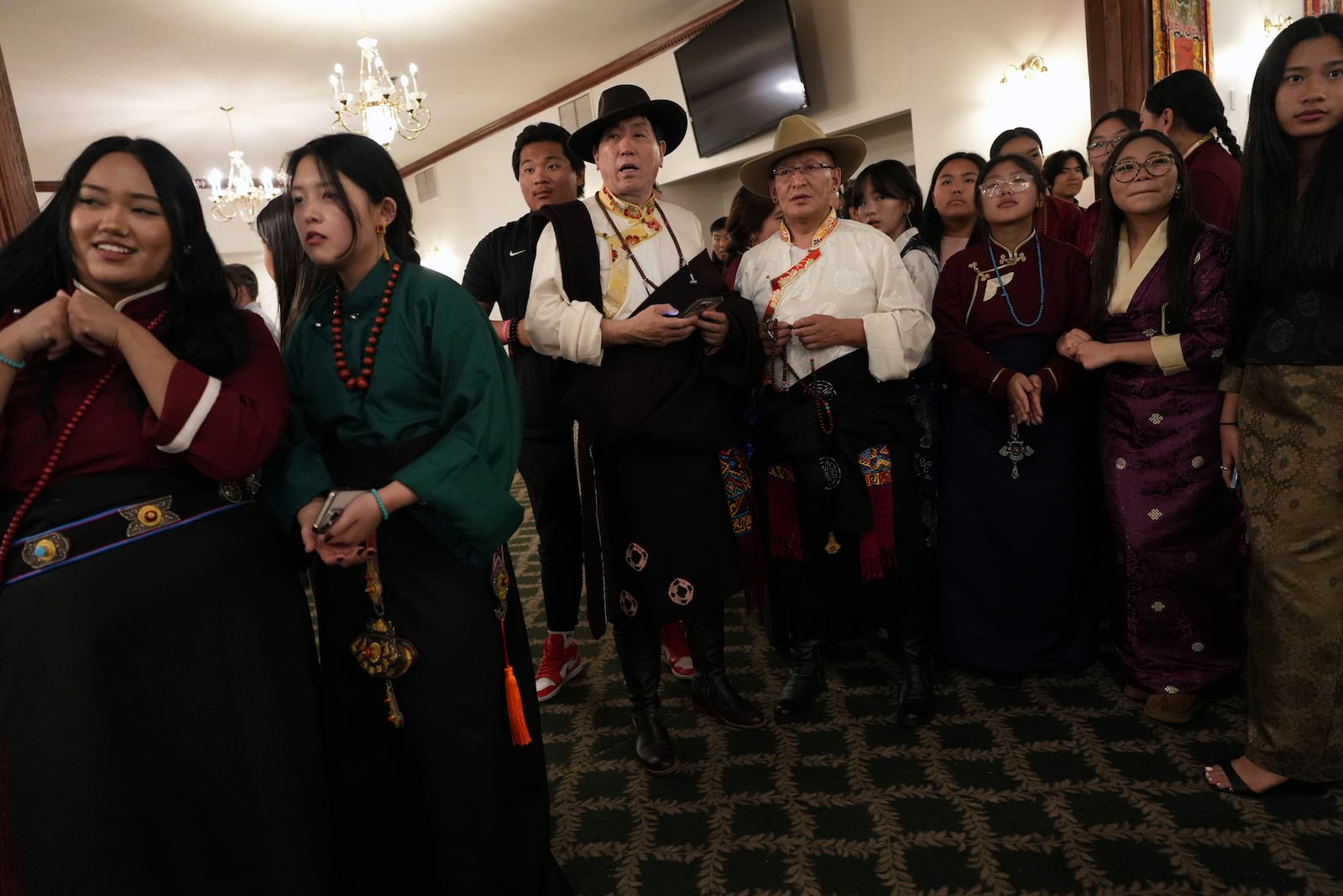 Guests prepare to welcome U.S.-born Buddhist lama, Jalue Dorje, during his 18th birthday and enthronement ceremony at the Tibetan American Foundation of Minnesota in Isanti, Minn., on Saturday, Nov. 9, 2024. (AP Photo/Luis Andres Henao)