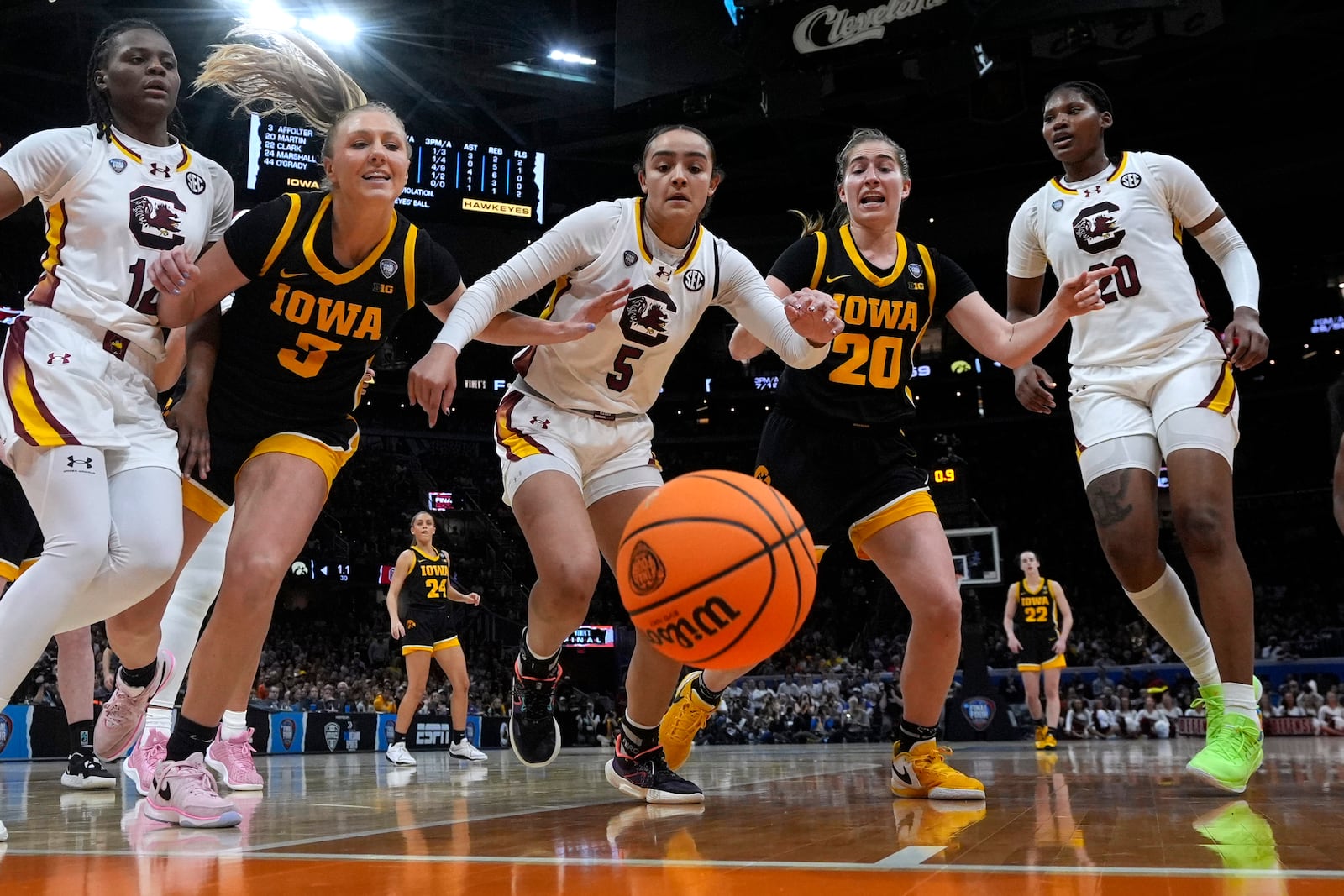 FILE - South Carolina guard Tessa Johnson (5) fights for a loose ball with Iowa guard Sydney Affolter (3) and guard Kate Martin (20) during the second half of the Final Four college basketball championship game in the women's NCAA Tournament, Sunday, April 7, 2024, in Cleveland. (AP Photo/Morry Gash, File)