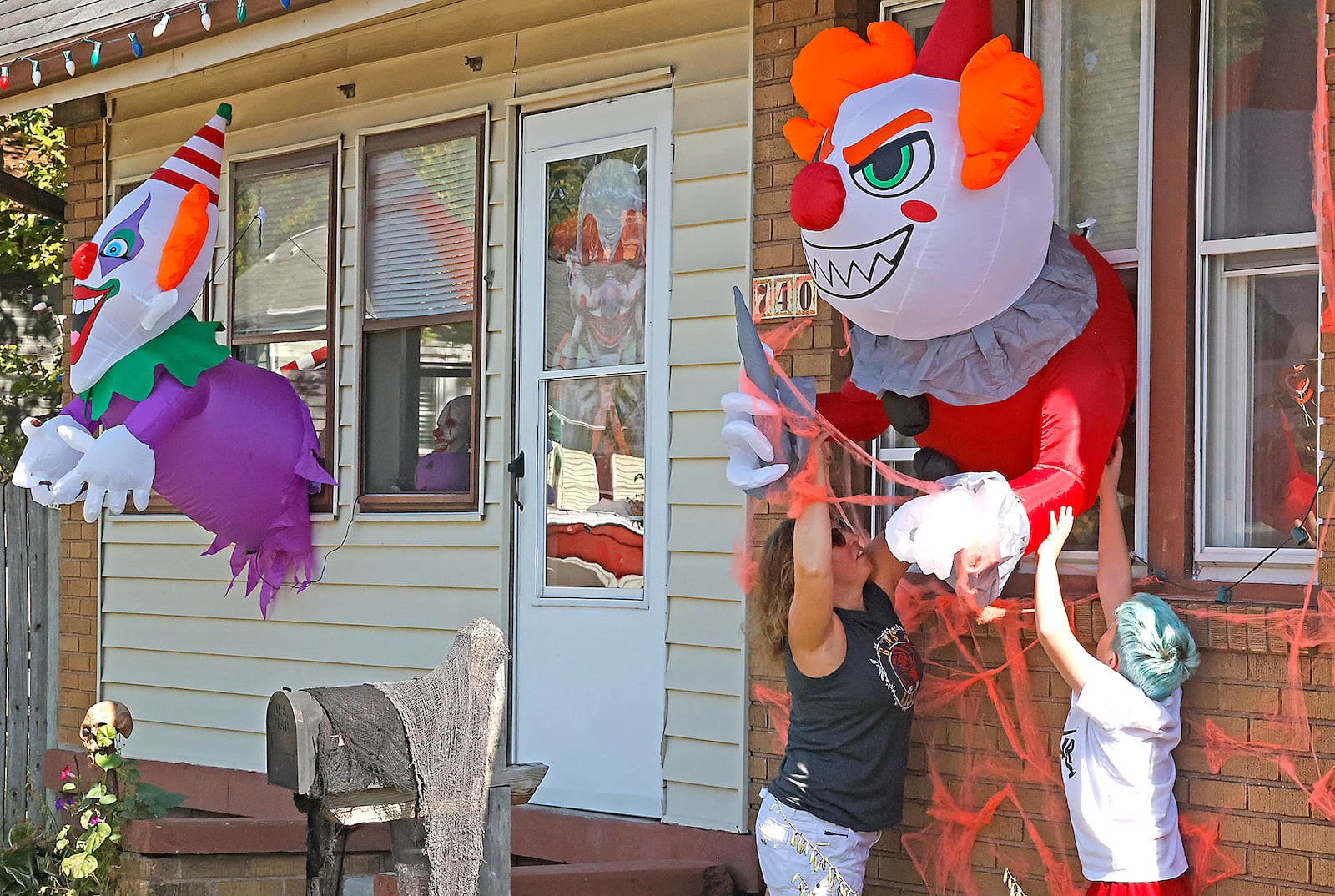 Arretta Adrian and her son, Corbin, are decorating their house along Rodgers Drive with a "Killer Clown" theme for Halloween Monday, Oct. 2, 2023. BILL LACKEY/STAFF