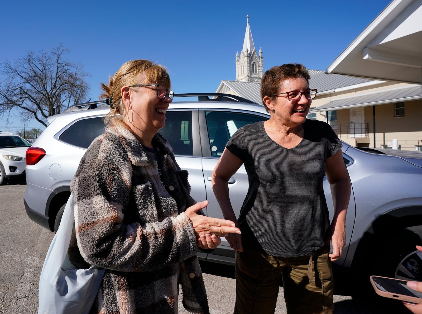 French tourist's Elisabeth Petrus and Marie Dominique De Fondaimiere describe their Crabapple Fire experience of evacuating from a vacation rental, Sunday, March 16, 2025, in Fredricksburg, Texas. (Robin Jerstad/The San Antonio Express-News via AP)