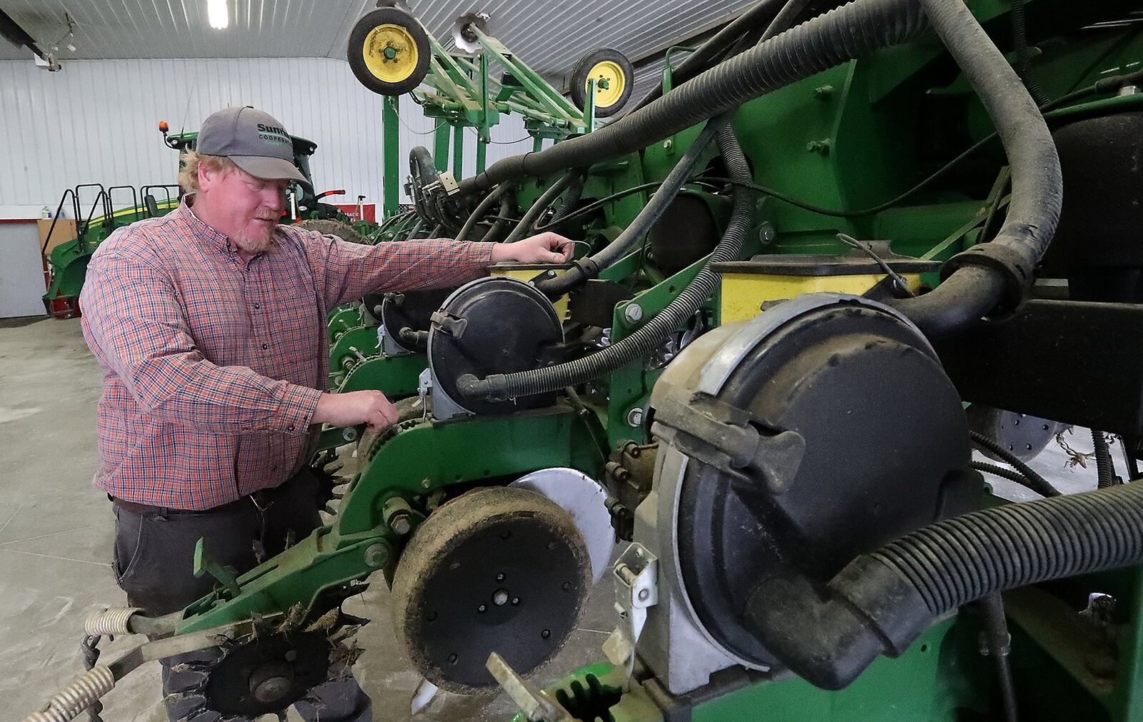 Clark County farmer Brian Harbage makes sure his planter is ready for nice weather so he can start planting his crops. BILL LACKEY/STAFF