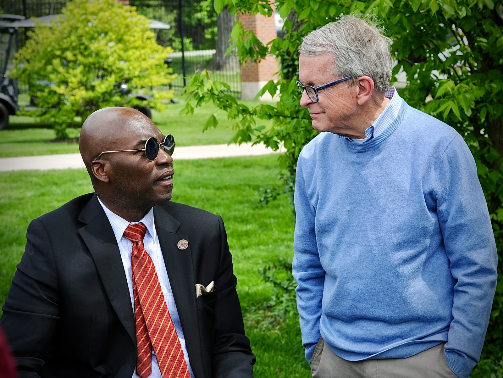 Central State University incoming president, Morakinyo A.O. Kuti talks with Ohio governor Mike DeWine at an Arbor Day tree planting event at the university Friday, April 26, 2024. MARSHALL GORBY \STAFF