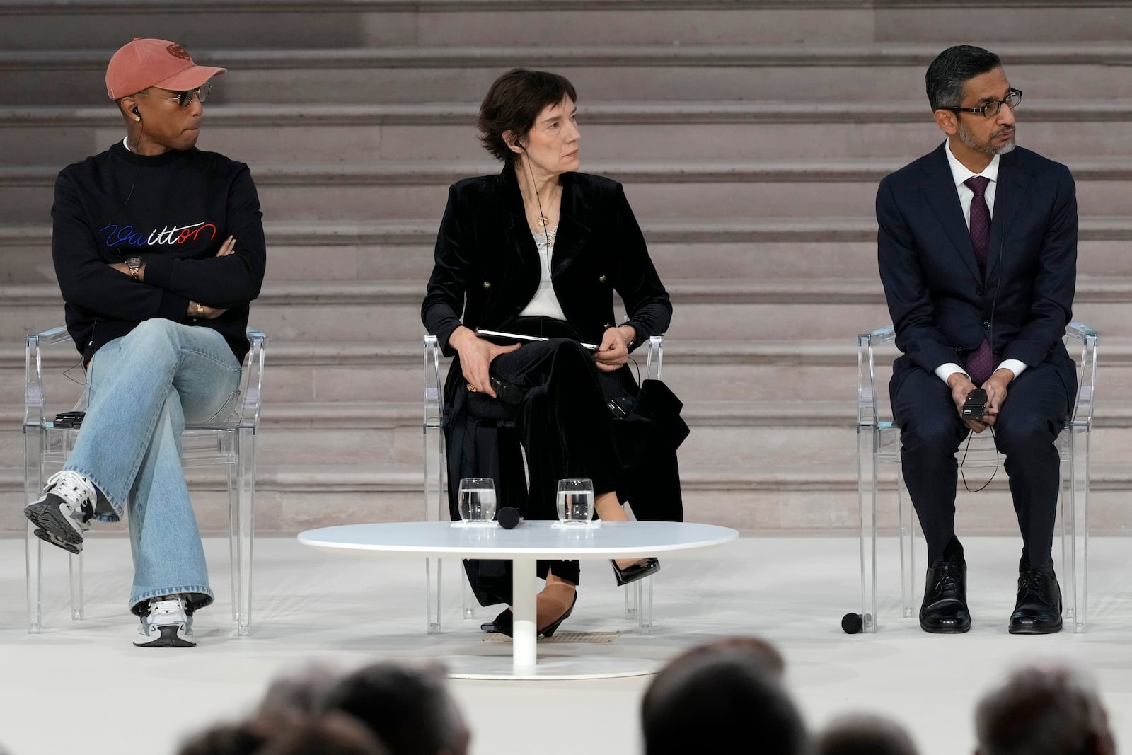 Musician and fashion designer Pharrell Williams, left, and Google CEO Sundar Pichai, right, listen to an address by United States Vice-President JD Vance at the Grand Palais during the Artificial Intelligence Action Summit in Paris, Tuesday, Feb. 11, 2025. (AP Photo/Michel Euler)