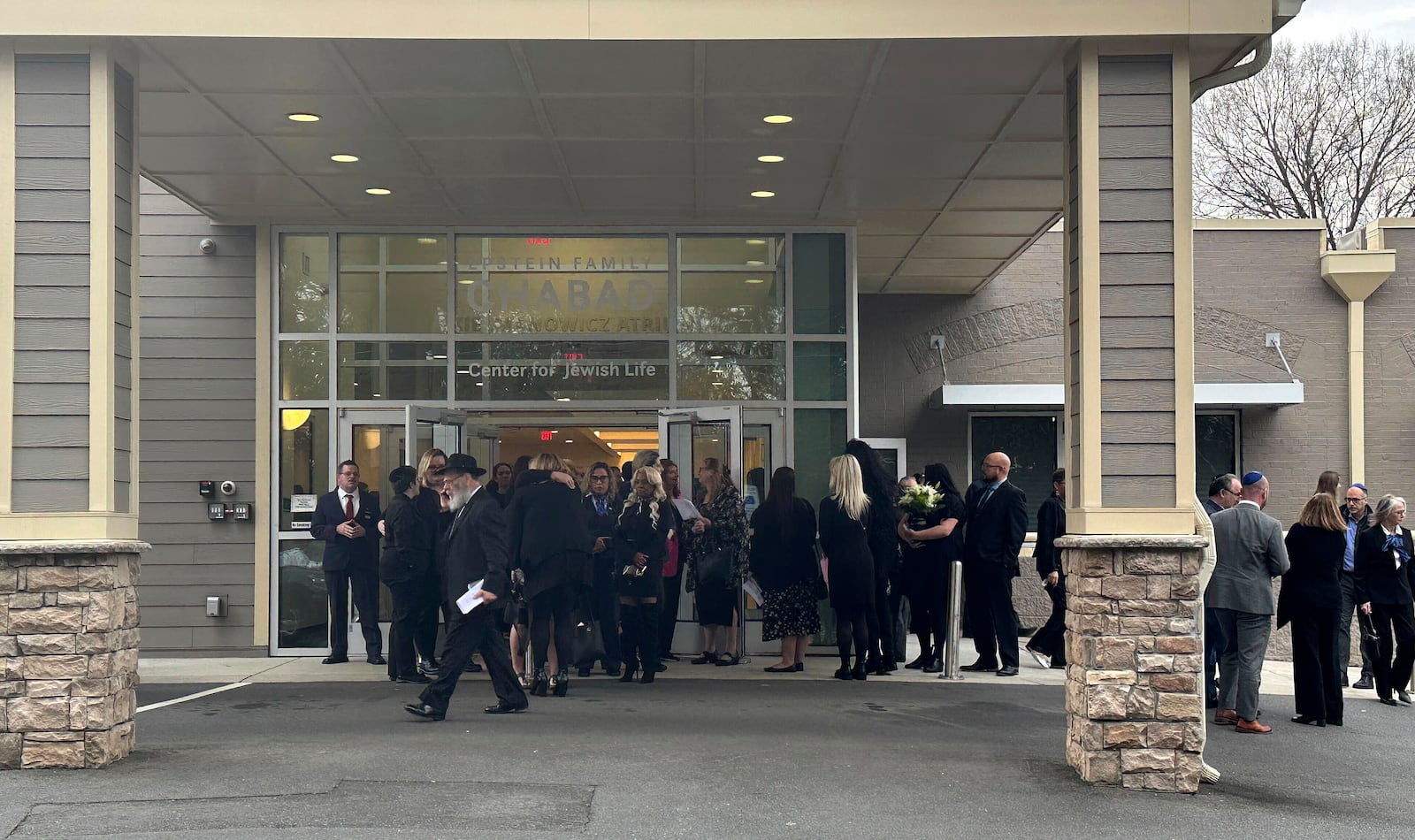 Friends and family of flight attendant Ian Epstein leave the venue from his Celebration of Life, Wednesday Feb. 5, 2025 in Charlotte, N.C. (AP Photo/Jeffrey Collins)