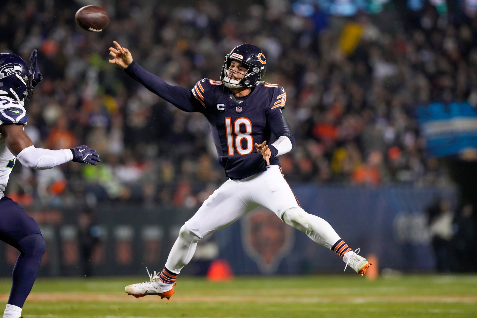 Chicago Bears quarterback Caleb Williams attempts a pass against the Seattle Seahawks during the first half of an NFL football game, Thursday, Dec. 26, 2024, in Chicago. (AP Photo/Nam Y. Huh)