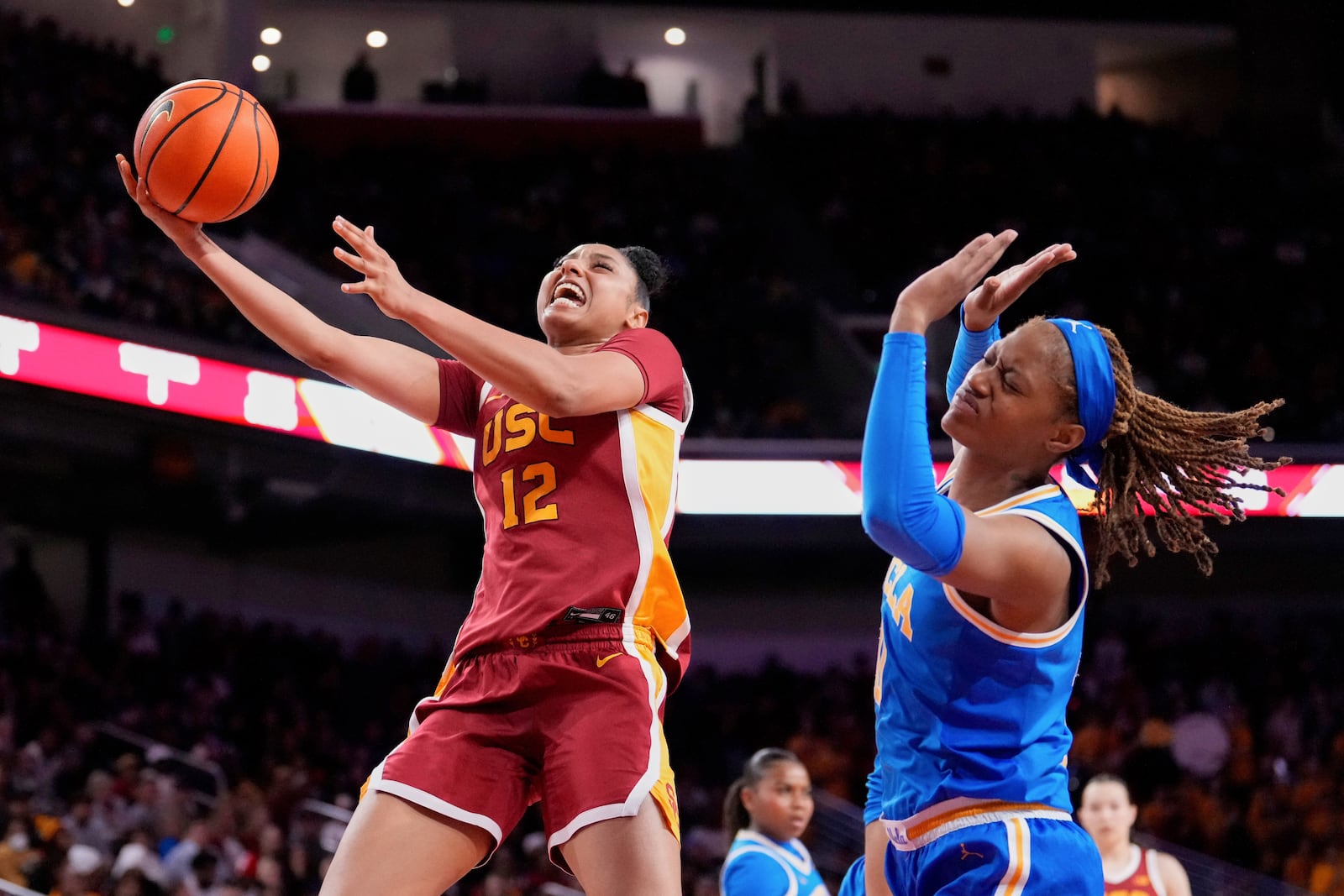 FILE - Southern California guard JuJu Watkins, left, shoots as UCLA forward Janiah Barker defends during the second half of an NCAA college basketball game, Thursday, Feb. 13, 2025, in Los Angeles. (AP Photo/Mark J. Terrill, File)