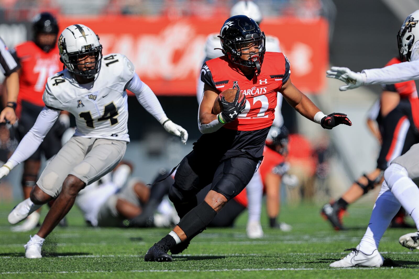 Cincinnati running back Ryan Montgomery (22) carries the ball during the second half of an NCAA college football game against UCF, Saturday, Oct. 16, 2021, in Cincinnati. Cincinnati won 56-21. (AP Photo/Aaron Doster)