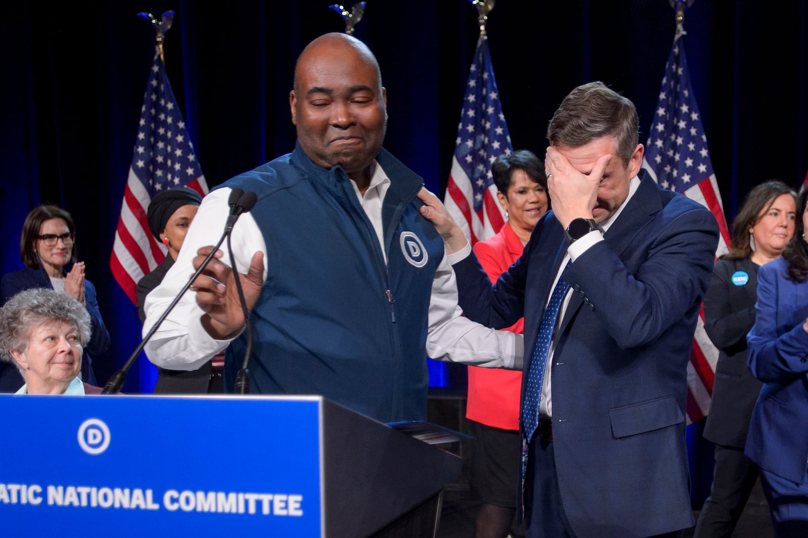 Former Democratic National Committee Chairman Jamie Harrison, left, stands next to newly elected DNC Chairman Ken Martin, right, as Martin reacts after winning the vote at the Democratic National Committee Winter Meeting at the Gaylord National Resort and Convention Center in National Harbor, Md., Saturday, Feb. 1, 2025. (AP Photo/Rod Lamkey, Jr.)