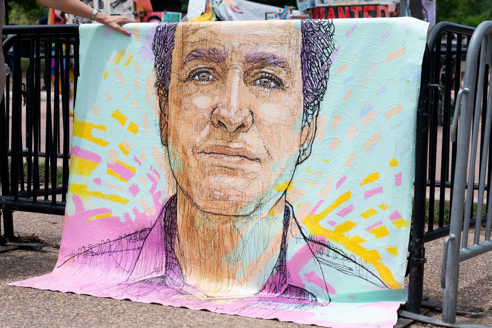 FILE - A drawn portrait of Marc Fogel, who has been detained in Russia since August 2021, hangs on rails outside of the White House during a demonstration organized by his family, July 15, 2023, in Washington. (AP Photo/Stephanie Scarbrough, File)