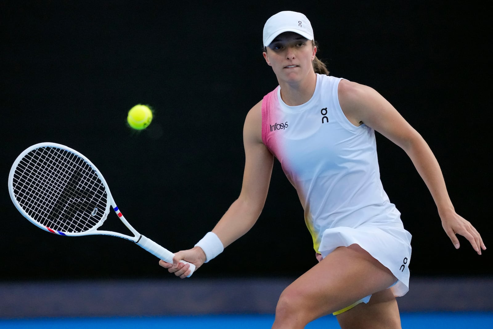 Iga Swiatek of Poland plays a forehand return to Eva Lys of Germany during their fourth round match at the Australian Open tennis championship in Melbourne, Australia, Monday, Jan. 20, 2025. (AP Photo/Vincent Thian)