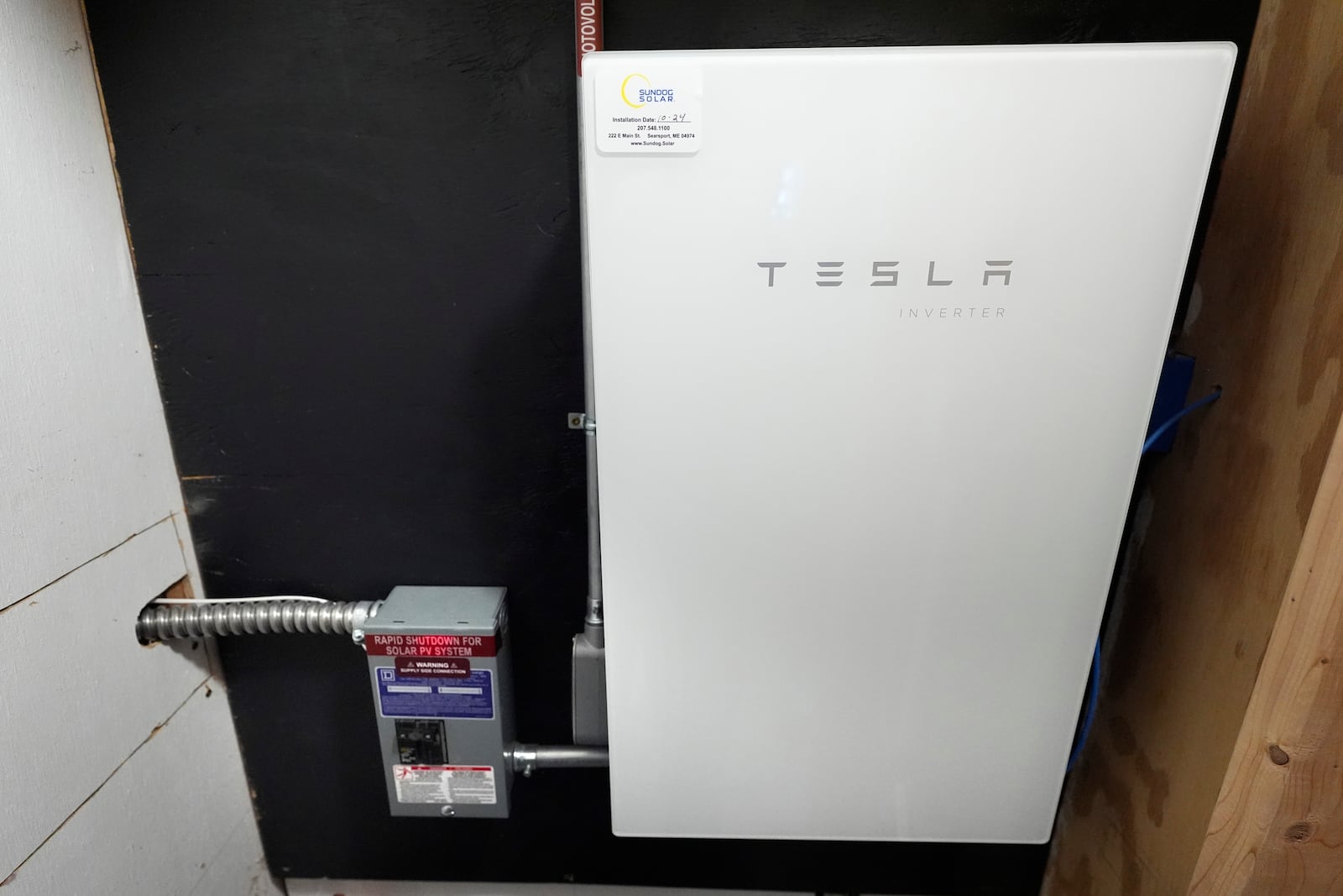 A Tesla power inverter is used in gathering electricity from an array of solar panels at Intervale Farm, Monday, Feb. 10, 2025, in Cherryfield, Maine. (AP Photo/Robert F. Bukaty)