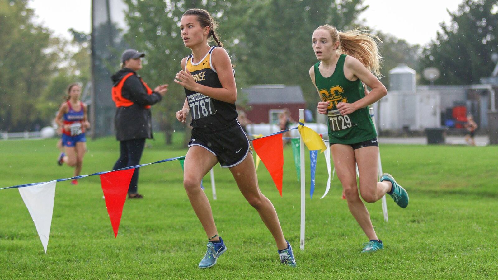 Cutline 3: Shawnee’s Audrey DeSantis and Catholic Central’s Addie Engel race around a curve at the Clark County Cross Country Championships at Young’s Dairy on Tuesday, Oct. 2, 2018. Michael Cooper/CONTRIBUTED