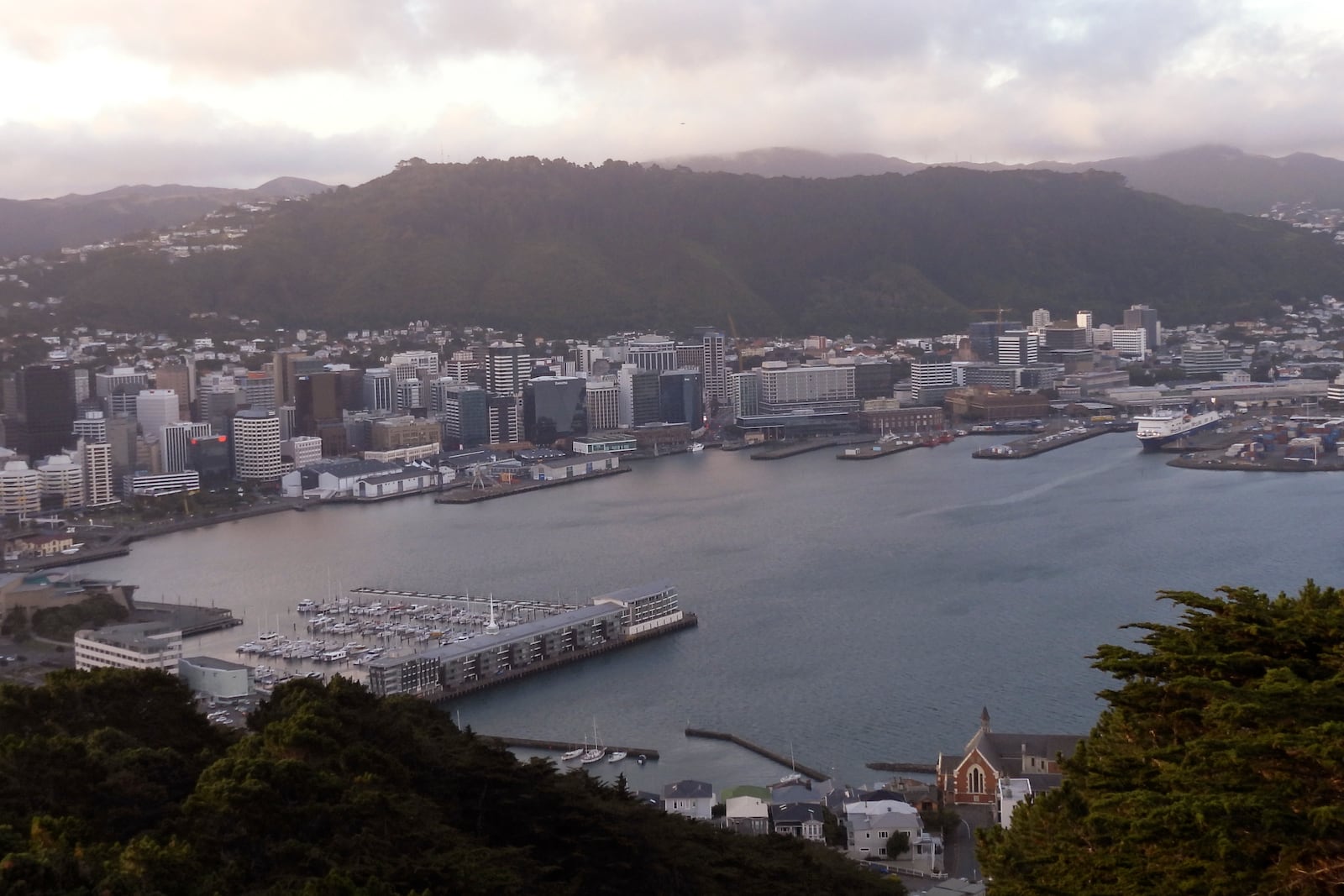 A ferry is docket, top right, in Wellington's harbor, New Zealand, on Tuesday, Jan. 7, 2025. (AP Photo/Charlotte Graham-McLay)