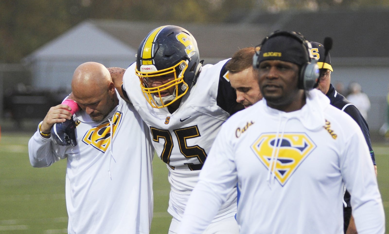 Springfield’s Isaiah Gibson is helped off the field as Wildcats coach Maurice Douglass (right) grimaces. Springfield lost 25-7 at Northmont in a Week 7 high school football game on Friday, Oct. 5, 2018. MARC PENDLETON / STAFF