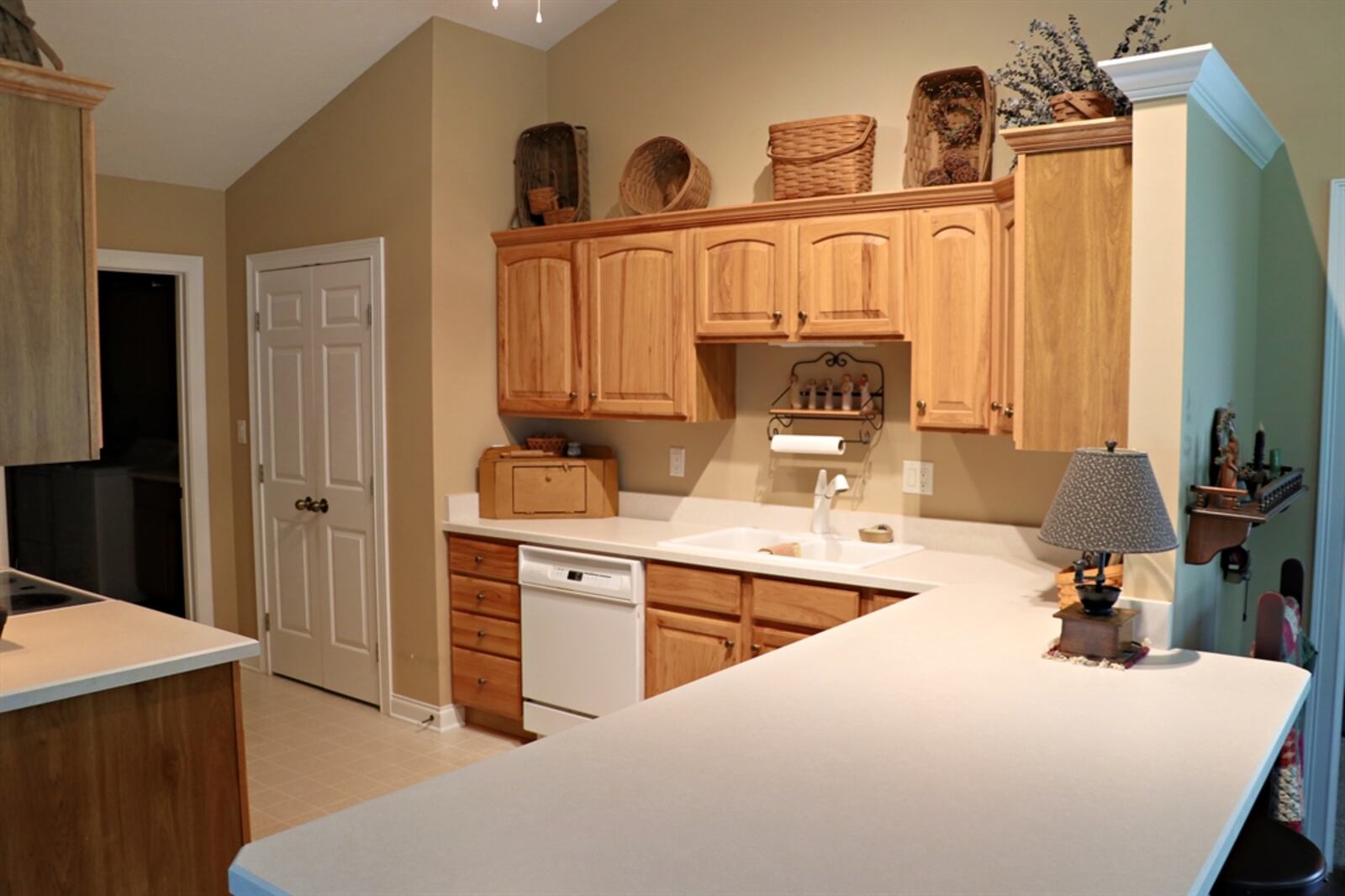 In the kitchen, cabinetry fills both wall.