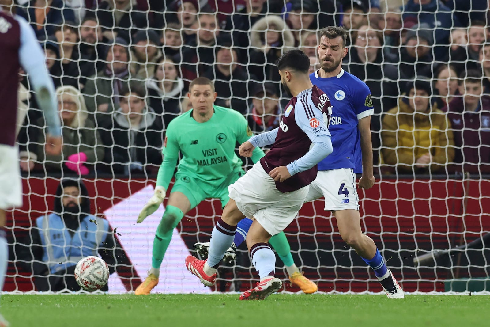 Aston Villa's Marco Asensio, centre, scores the opening goal during the English FA Cup fifth round soccer match between Aston Villa and Cardiff City at the Villa Park stadium in Birmingham, England, Friday, Feb. 28, 2025. (AP Photo/Darren Staples)