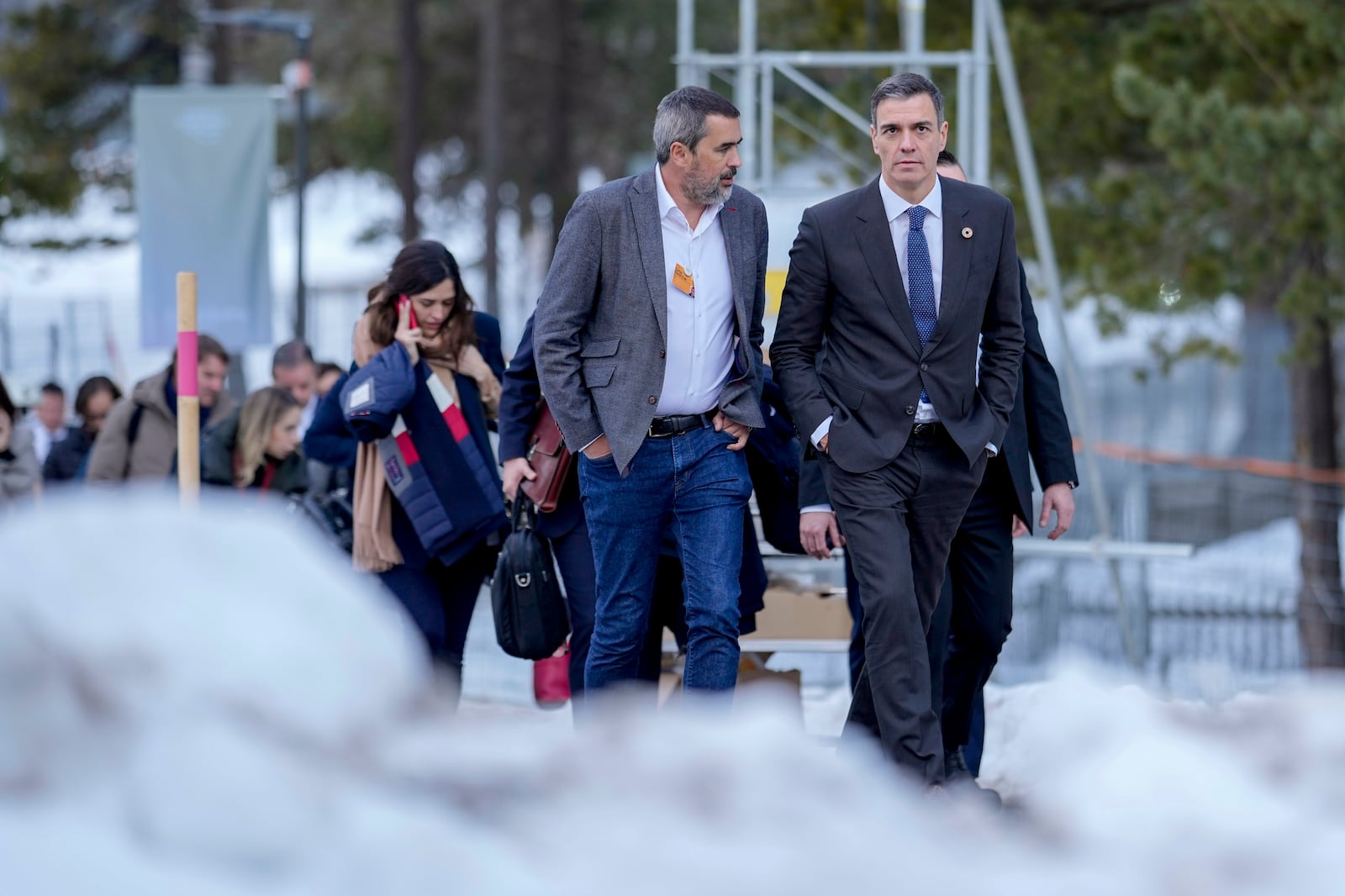 Prime Minister of Spain Pedro Sanchez, right, walks in the snow at the Annual Meeting of World Economic Forum in Davos, Switzerland, Wednesday, Jan. 22, 2025. (AP Photo/Markus Schreiber)