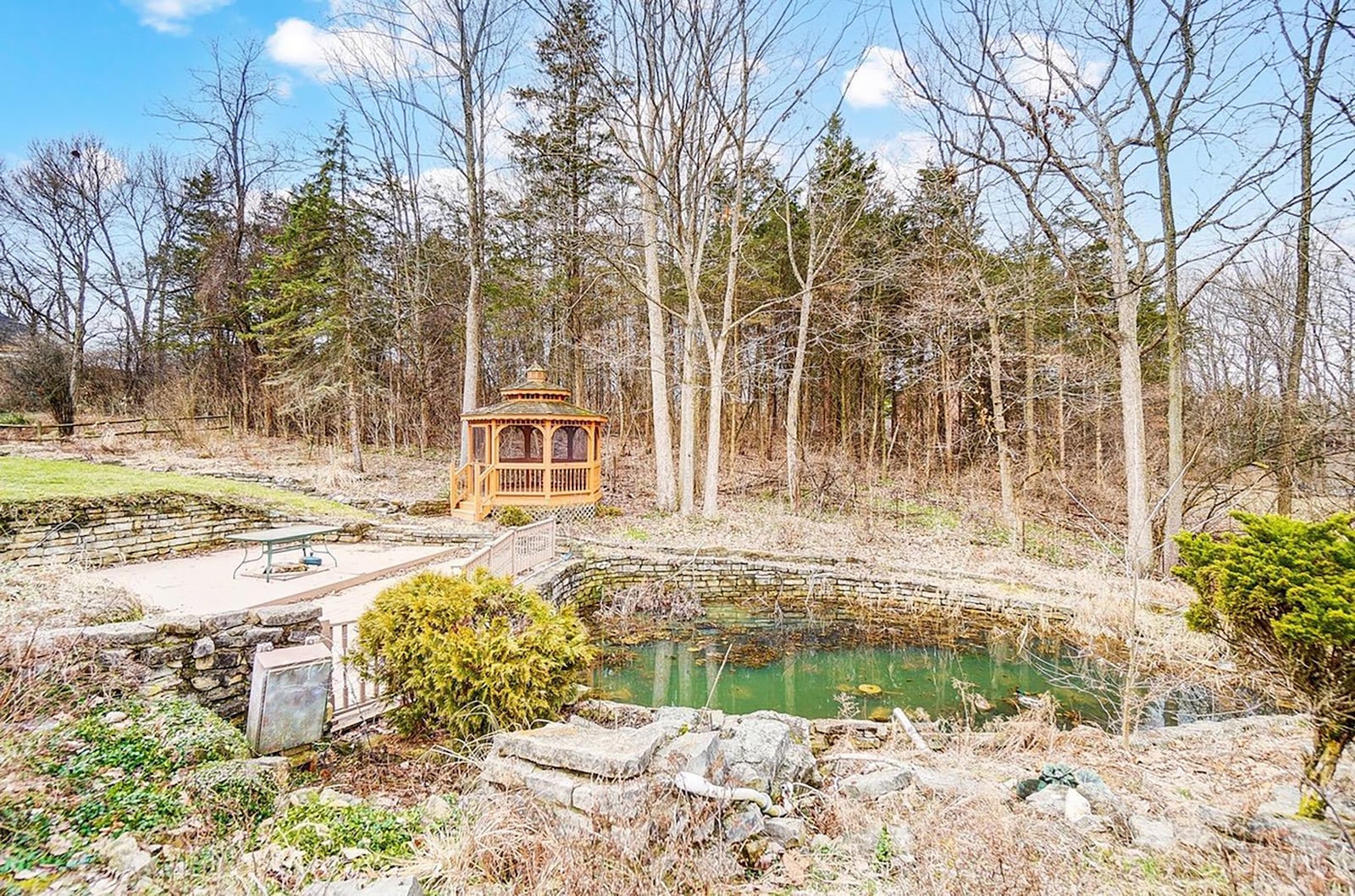 There is a pond on the property and a screened in wood gazebo.