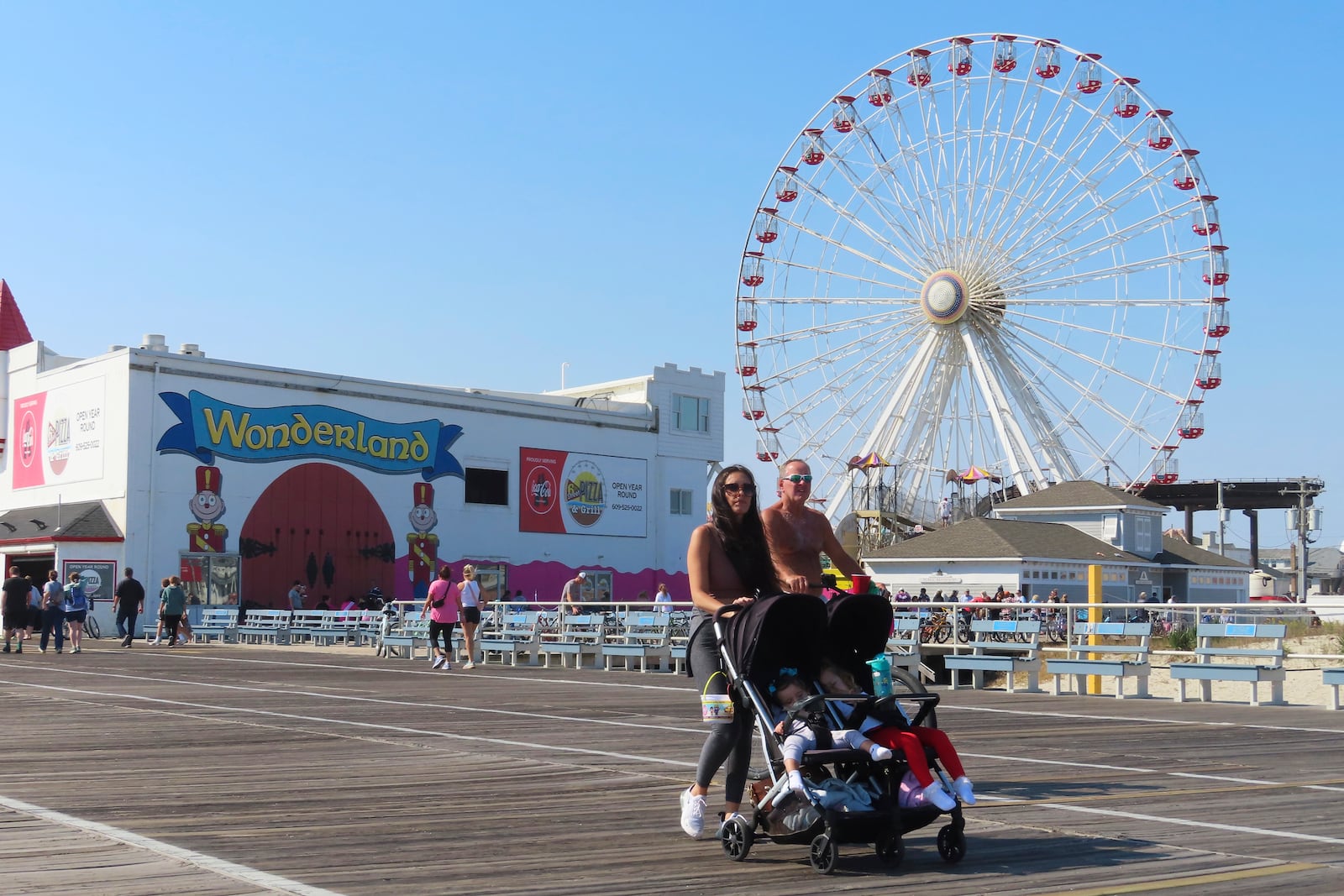 People walk past Gillian's Wonderland, the popular amusement park on the boardwalk in Ocean City, N.J., during its final day of operation before shutting down for good, Sunday, Oct. 13, 2024. (AP Photo/Wayne Parry)