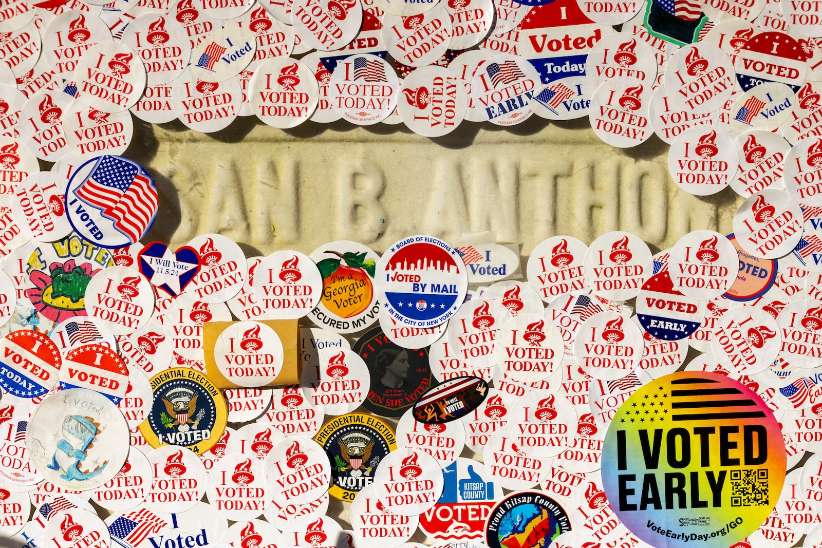 The headstone of Susan B. Anthony is covered in "I voted" stickers at Mount Hope Cemetery in Rochester, N.Y., on Election Day, Tuesday, Nov. 5, 2024. (AP Photo/Lauren Petracca)