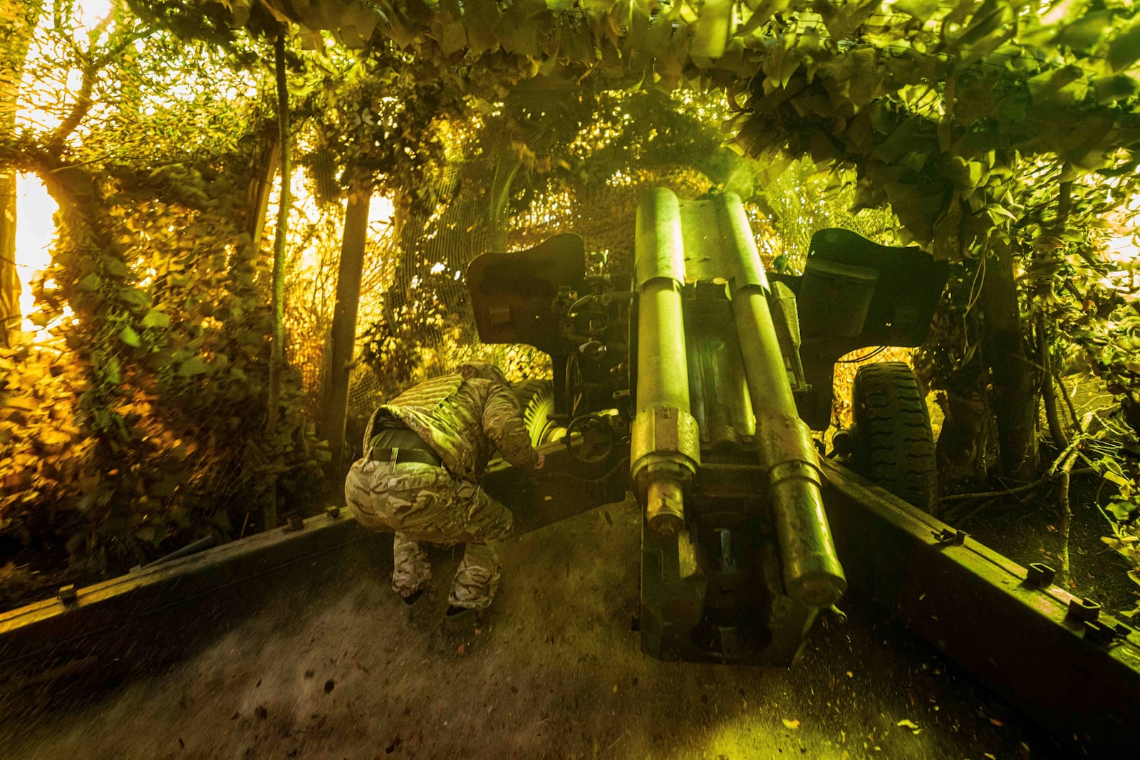 A Ukrainian serviceman of 14th National Guard "Chervona Kalyna" brigade fires by d-20 artillery cannon towards Russian positions at the frontline on Pokrovsk direction, Donetsk region, Ukraine, Monday Jan. 20, 2025. (AP Photo/Evgeniy Maloletka)