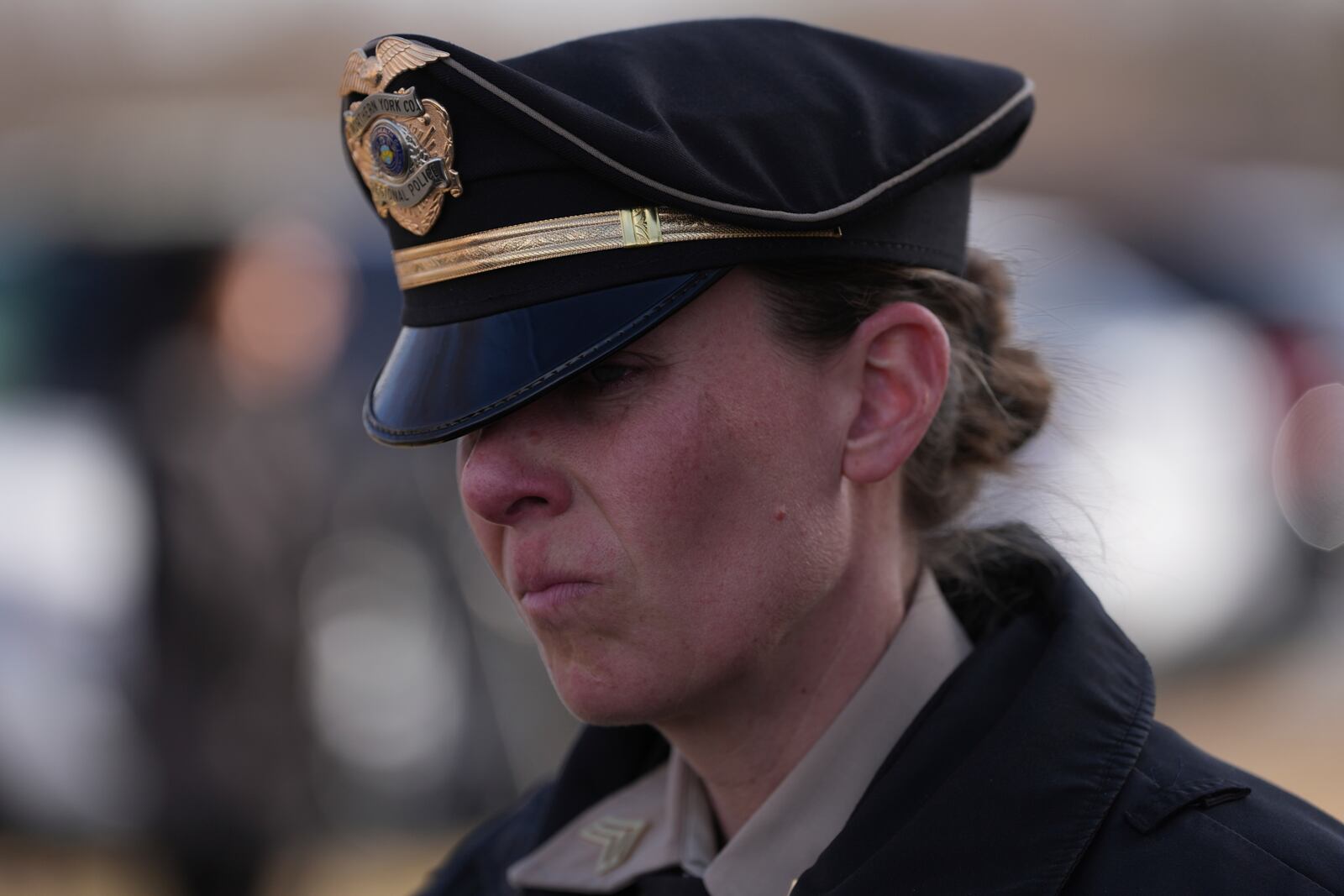 A police officer looks on as slain West York Borough Police Officer Andrew Duarte's funeral procession departs from Living Word Community Church, in Red Lion, Pa., Friday, Feb. 28, 2025. (AP Photo/Matt Rourke)