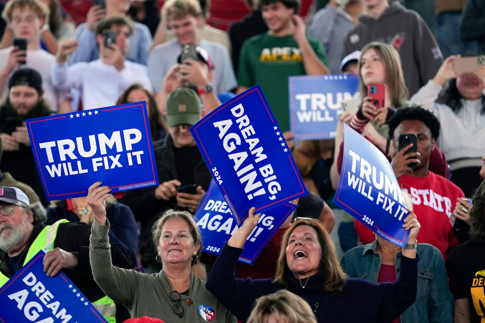 Supporters get ready before Republican presidential nominee former President Donald Trump arrives to speak to a campaign rally at J.S. Dorton Arena, Monday, Nov. 4, 2024, in Raleigh, N.C. (AP Photo/Evan Vucci)