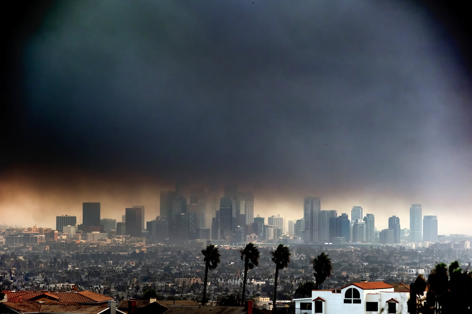 Thick heavy smoke from wildfires shrouds downtown Los Angeles on Wednesday, Jan. 8, 2025. (AP Photo/Richard Vogel)