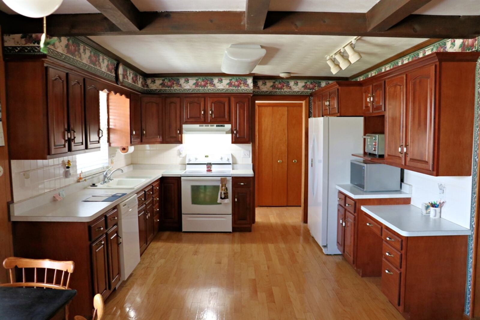 The hearth room and kitchen are open and spacious. Maple cabinetry fills three walls of the kitchen.