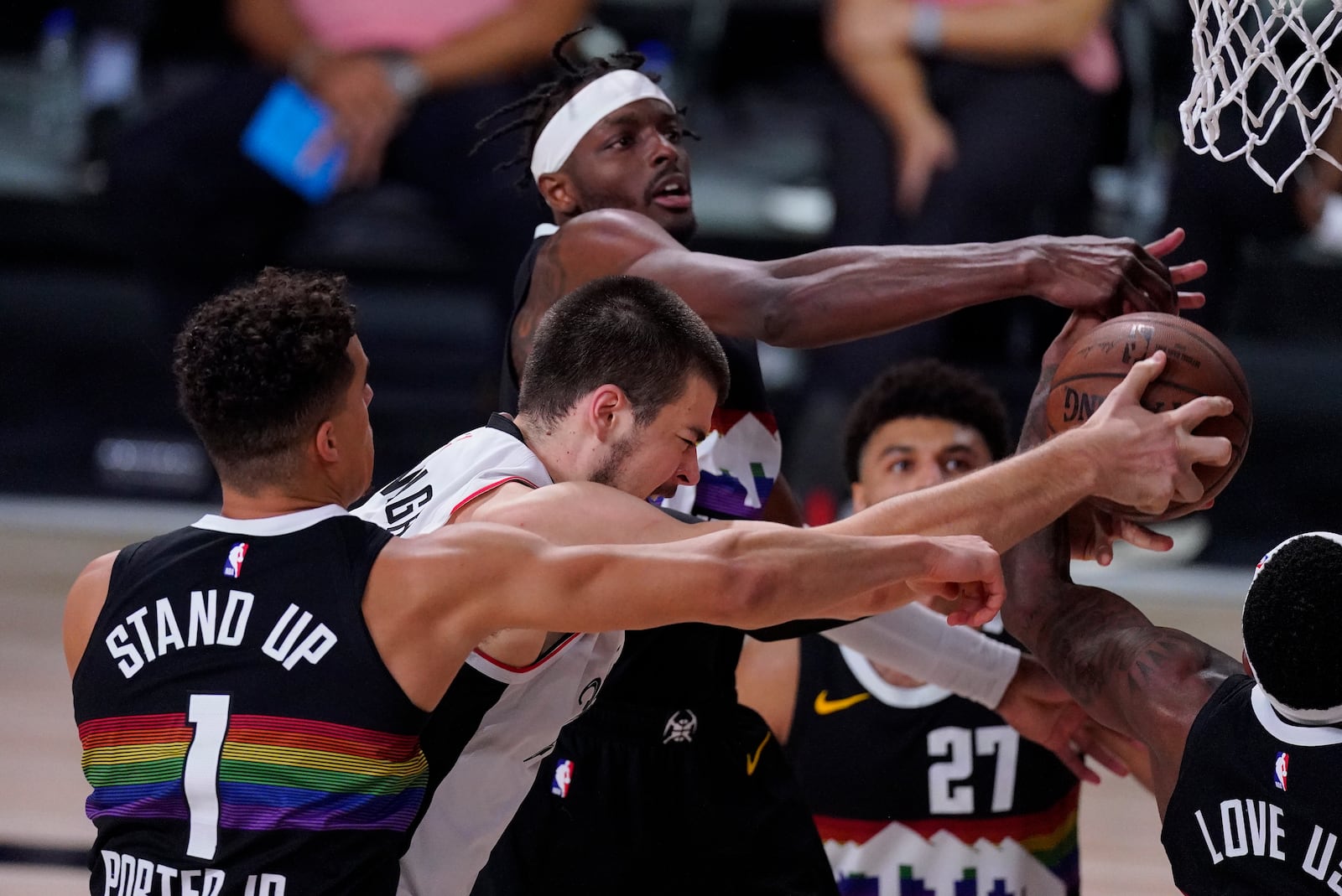 Los Angeles Clippers' Ivica Zubac (40) and Denver Nuggets' Michael Porter Jr. (1) reach for a rebound during the first half of an NBA conference semifinal playoff basketball game, Wednesday, Sept. 9, 2020, in Lake Buena Vista, Fla. (AP Photo/Mark J. Terrill)