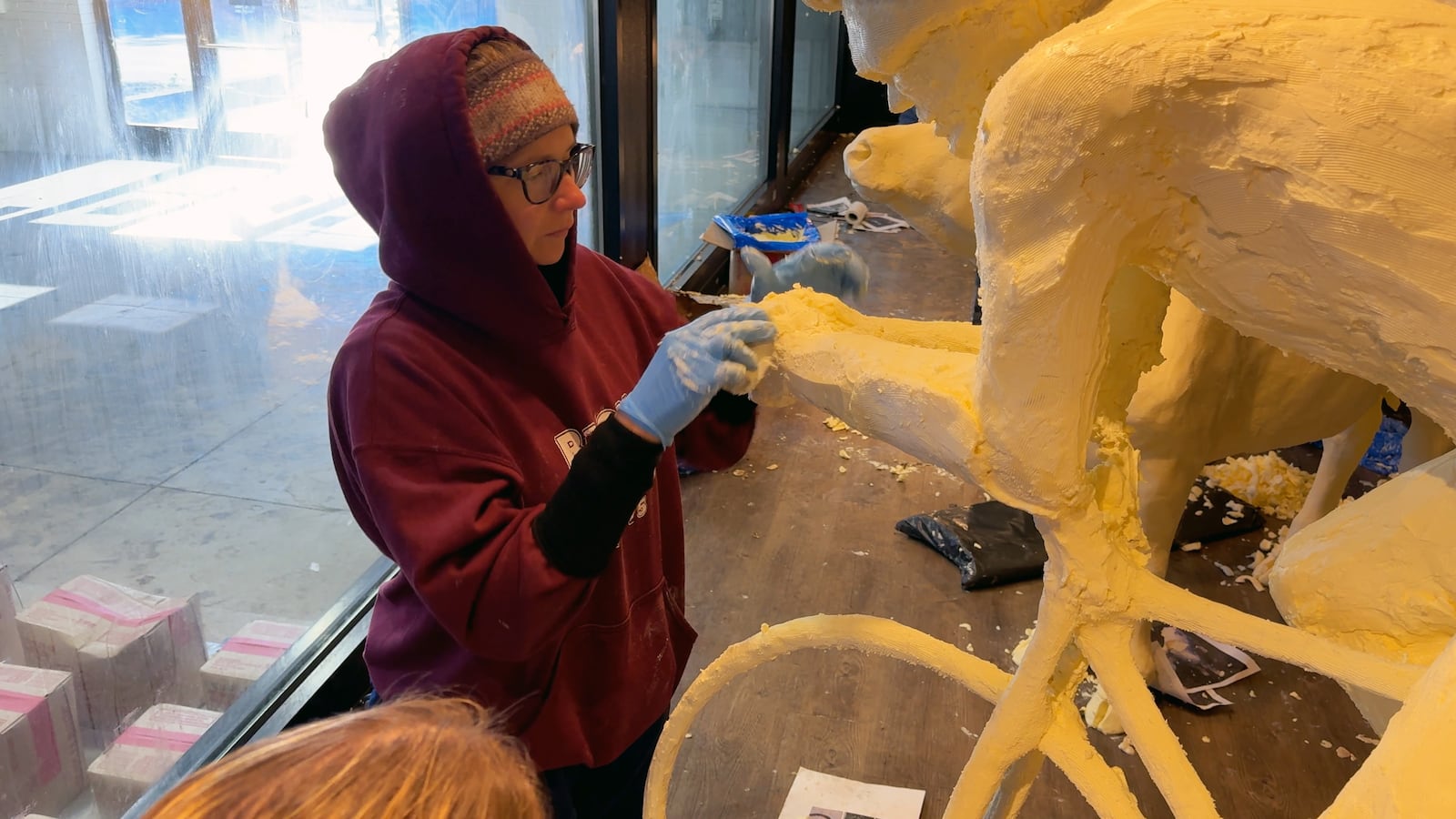 Tammy Buerk, of West Chester, works on the sculpture of a cyclist for the American Dairy Association Mideast’s butter cow display (CONTRIBUTED PHOTO).