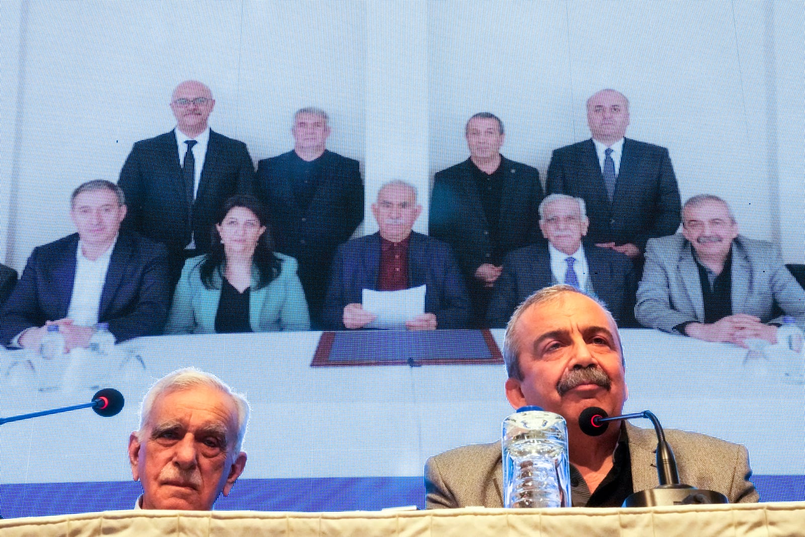 Pro-Kurdish Peoples' Equality and Democracy Party, or DEM, delegation members release an statement from the jailed leader of the rebel Kurdistan Workers' Party, or PKK, Abdullah Ocalan, center at the background photo, in Istanbul, Turkey, Thursday, Feb. 27, 2025. (AP Photo/Khalil Hamra)