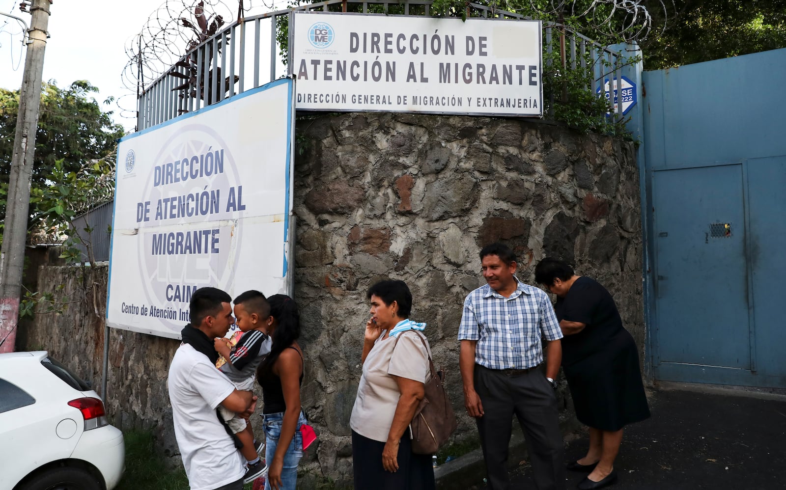 FILE - People gather outside the Migrant Assistance Office on Oct. 9, 2019 in San Salvador, El Salvador. (AP Photo/Eduardo Verdugo, File)