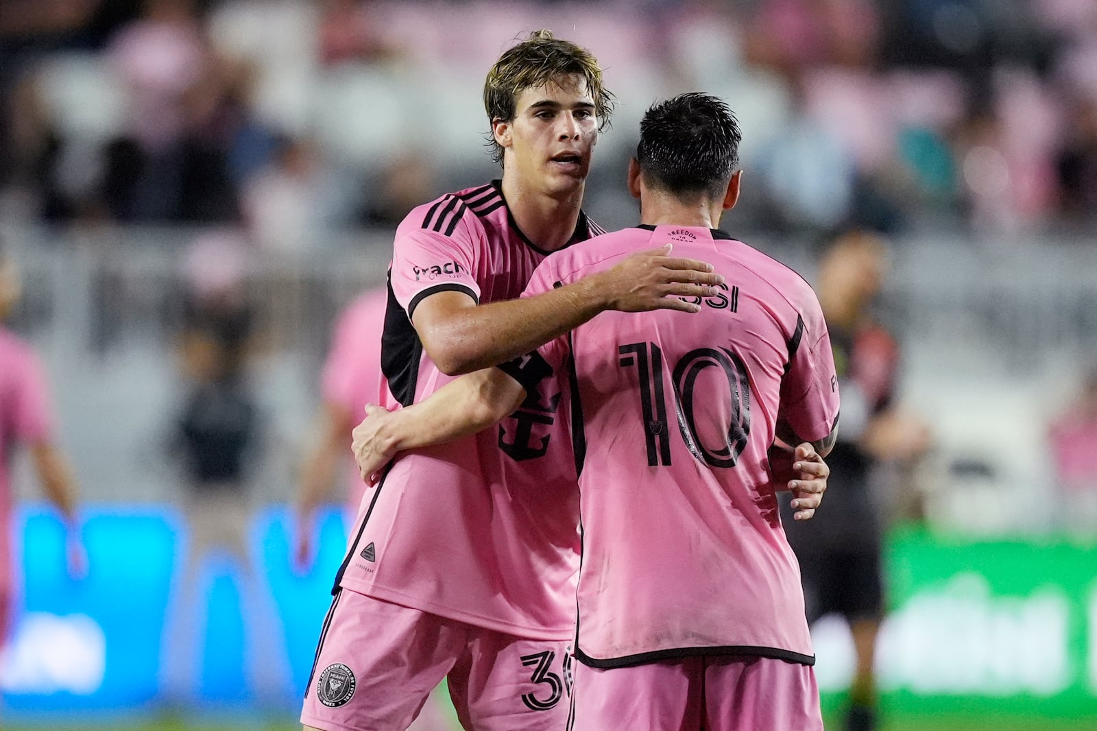 Inter Miami midfielder Benjamin Cremaschi (30) and forward Lionel Messi (10) celebrate at the end of the second half of their MLS playoff opening round soccer match against Atlanta United, Friday, Oct. 25, 2024, in Fort Lauderdale, Fla. (AP Photo/Rebecca Blackwell)