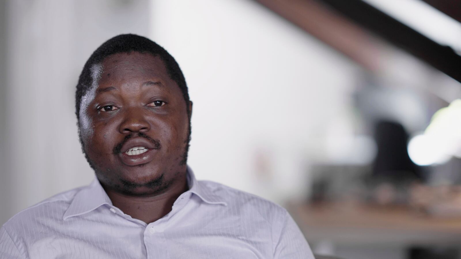 Whistleblower Ephrem Yaline-Ngonzo, who was recruited by Kremlin-backed Wagner forces to spread Russian propaganda in Central African Republic, sits for an interview in the offices of the Forbidden Stories NGO in Paris, France, Sept. 6, 2024. (Forbidden Stories via AP)