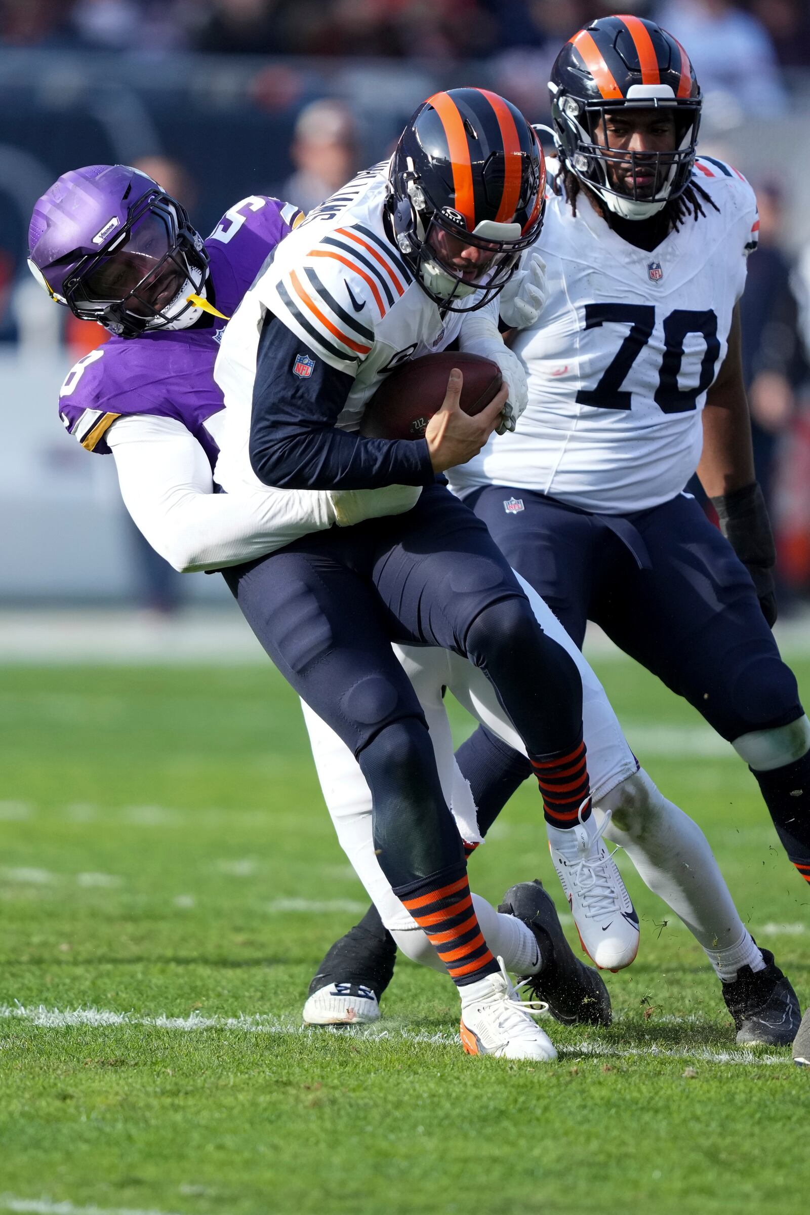 Chicago Bears quarterback Caleb Williams is sacked by Minnesota Vikings linebacker Jonathan Greenard (58) during the first half of an NFL football game Sunday, Nov. 24, 2024, in Chicago. (AP Photo/Charles Rex Arbogast)