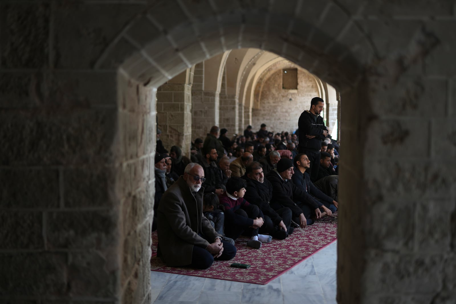 Palestinians take part in Friday prayers in the ruins of the Omari Mosque that was partially destroyed by Israeli bombardment, ahead of the start of the Muslim holy month of Ramadan in Gaza City, Gaza Strip, Friday, Feb. 28, 2025. (AP Photo/Abdel Kareem Hana)