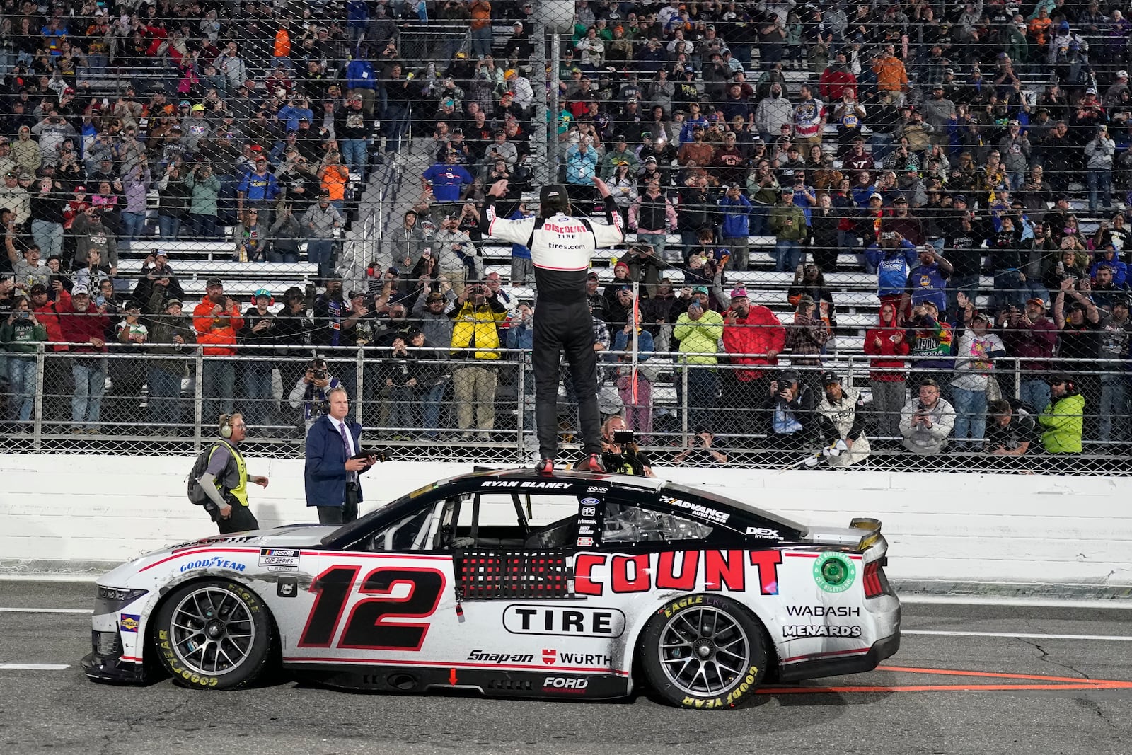 Ryan Blaney, centere, celebrates after winning a NASCAR Cup Series auto race at Martinsville Speedway in Martinsville, Va., Sunday, Nov. 3, 2024. (AP Photo/Chuck Burton)