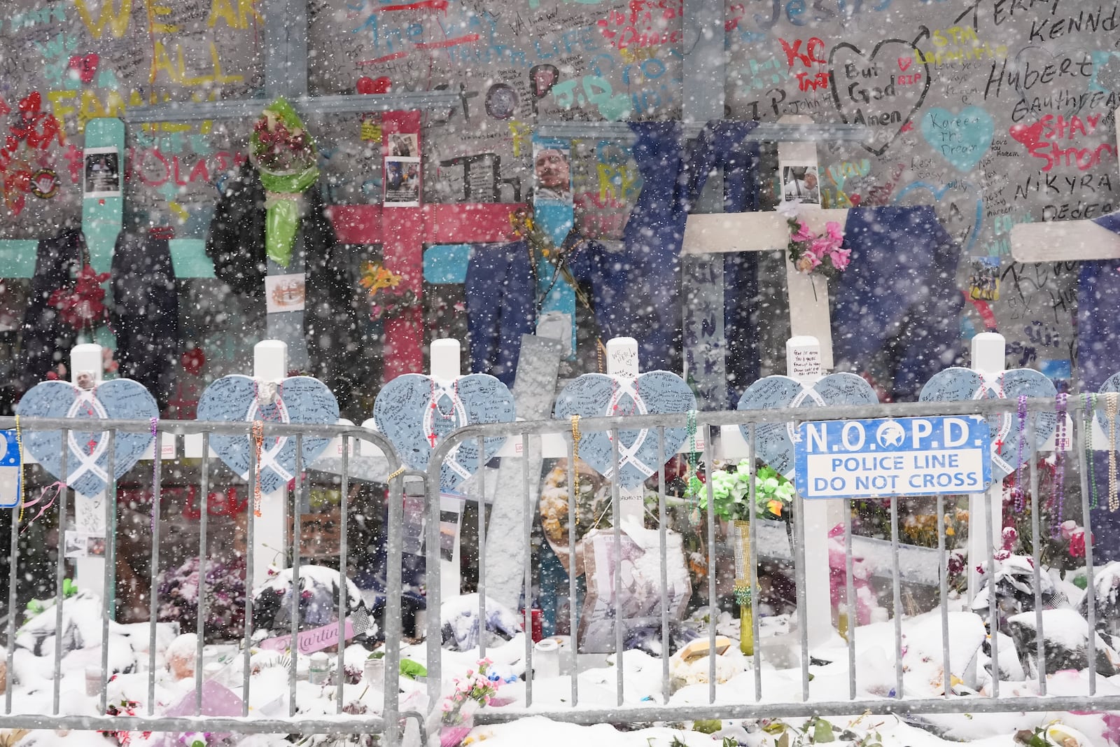 Snow falls as the memorial for the victims of a deadly truck attack on New Year's Day in the French Quarter is seen in New Orleans, Tuesday, Jan. 21, 2025. (AP Photo/Gerald Herbert)