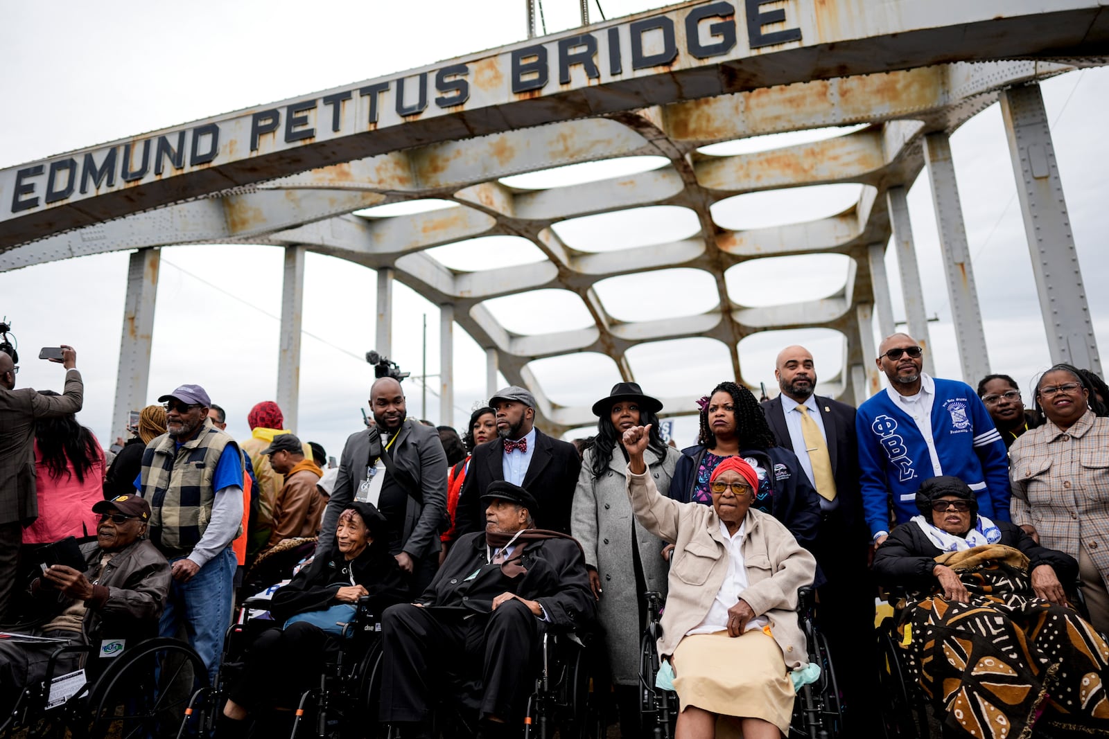 The foot soldiers are helped across the Edmund Pettus bridge during the 60th anniversary of the march to ensure that African Americans could exercise their constitutional right to vote, Sunday, March 9, 2025, in Selma, Ala. (AP Photo/Mike Stewart)