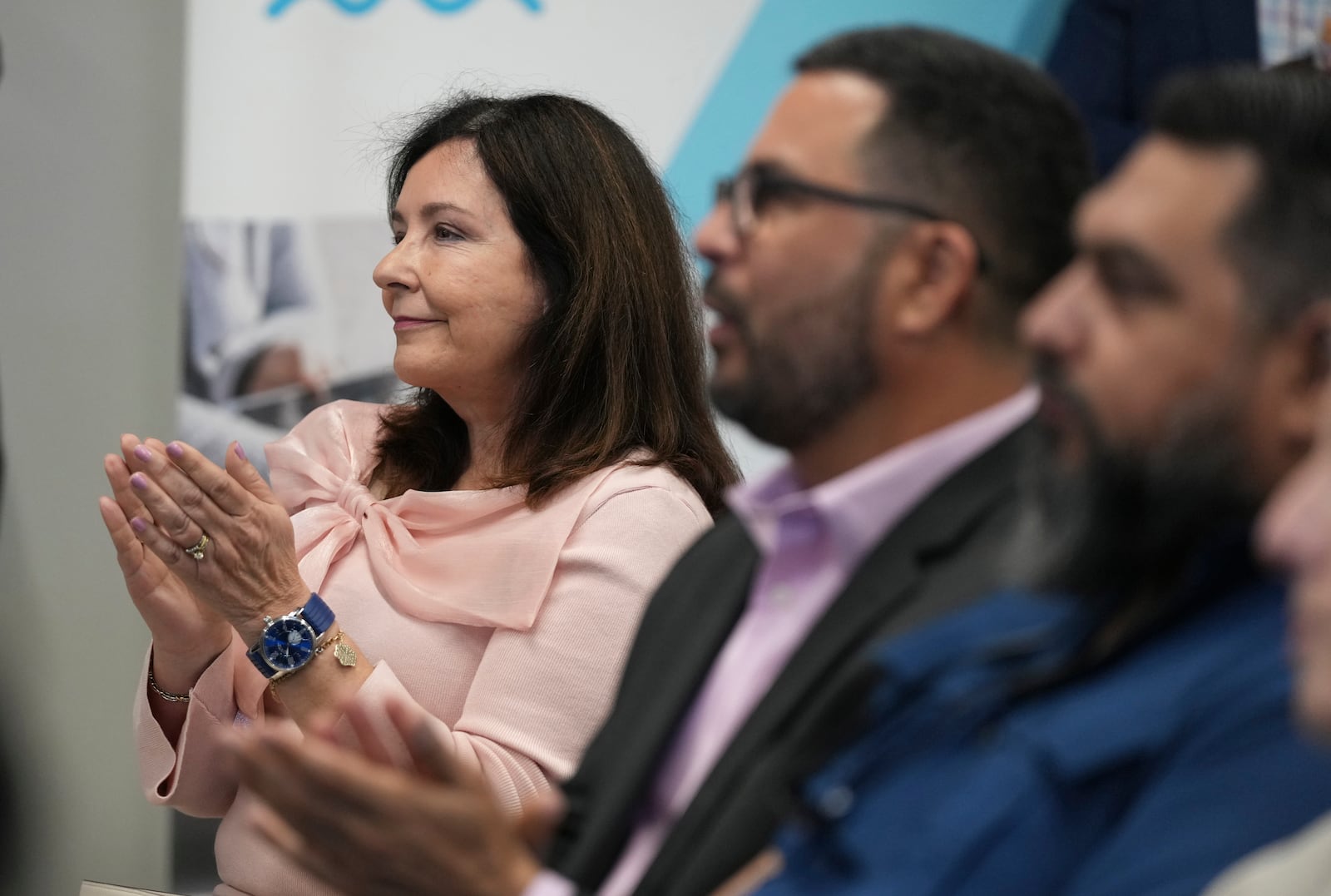 Vicky Lazo, a teacher with Southwest Miami Senior High School, applauds during a Hispanic Federation event in Miami, Tuesday, Jan. 28, 2025, where the organization announced a new investment from a company, to help Latinos learn digital skills. (AP Photo/Lynne Sladky)