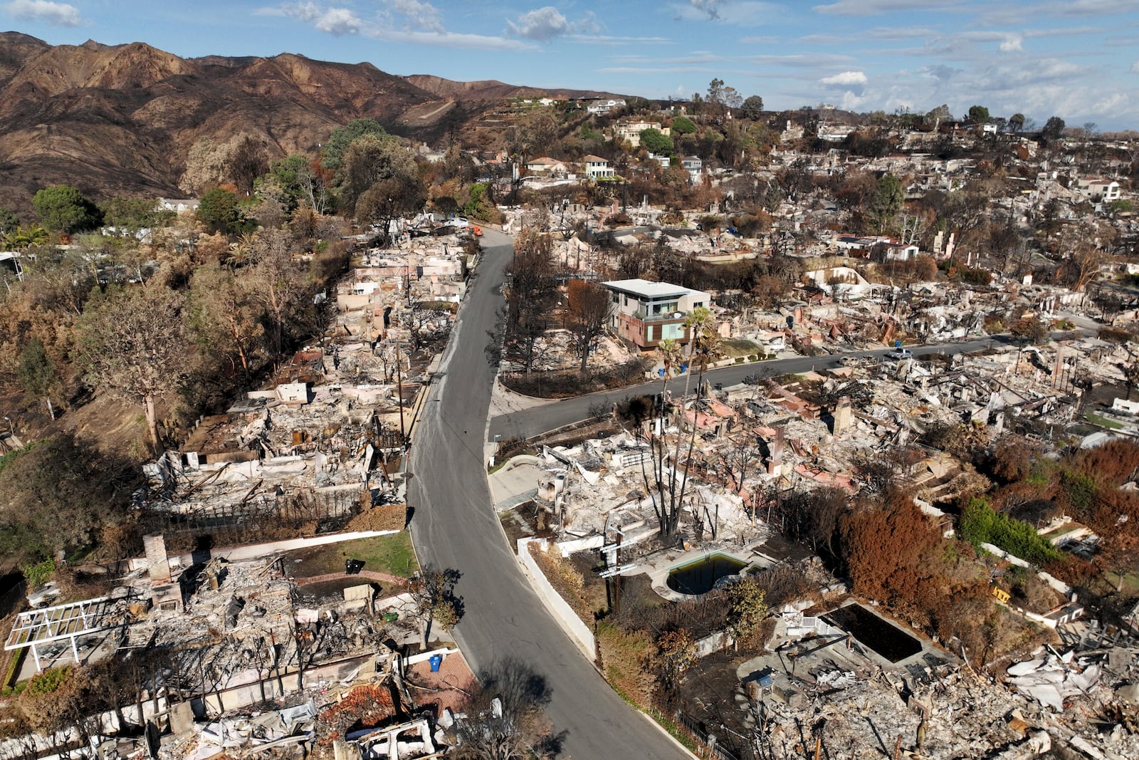 An aerial view shows the devastation left by the Palisades Fire in the Pacific Palisades section of Los Angeles, Monday, Jan. 27, 2025. (AP Photo/Jae C. Hong)