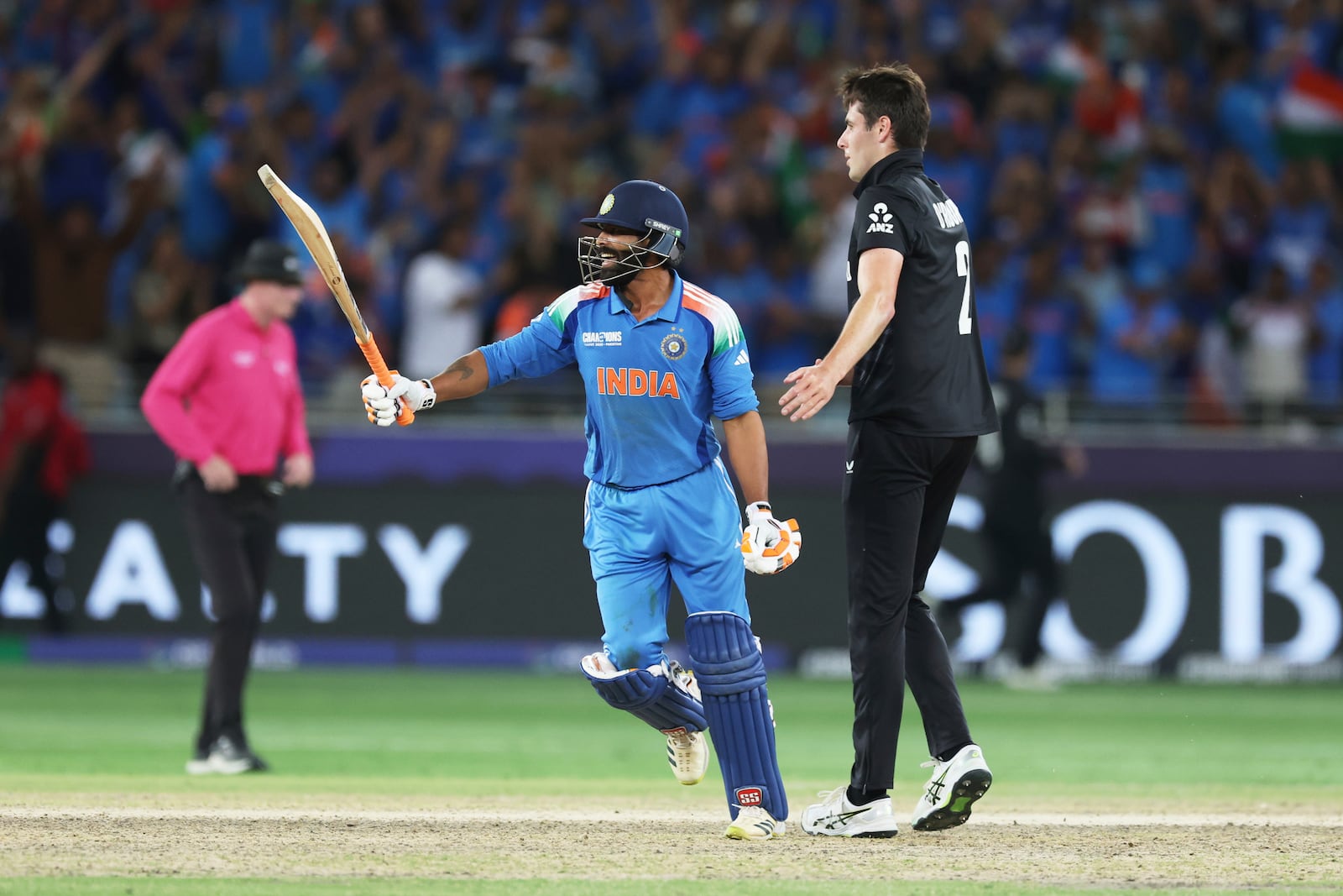 India's Ravindra Jadeja, left, collides with New Zealand's Will O'Rourke as he celebrates after scoring the winning runs for India during the ICC Champions Trophy final cricket match between India and New Zealand at Dubai International Cricket Stadium in Dubai, United Arab Emirates, Sunday, March 9, 2025. (AP Photo/Christopher Pike)