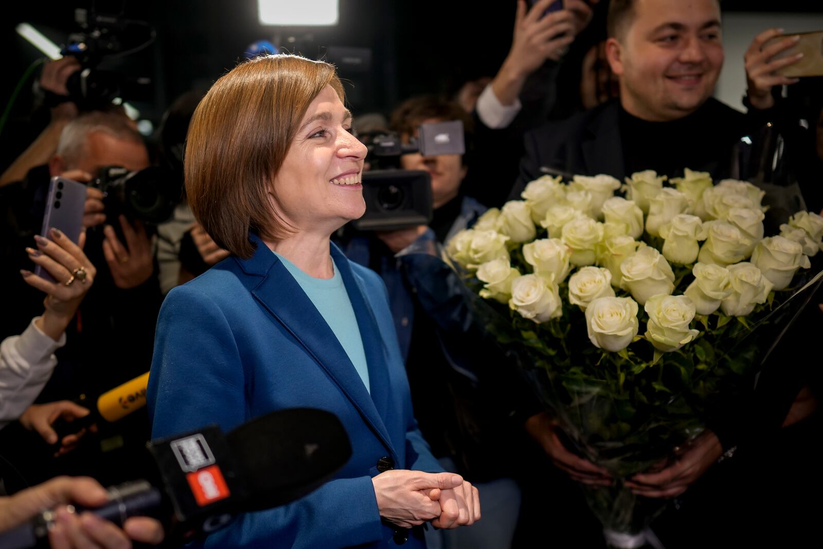 Moldova's President Maia Sandu celebrates with supporters as preliminary results are announced for the presidential election runoff in Chisinau, Moldova, Sunday, Nov. 3, 2024. (AP Photo/Vadim Ghirda)