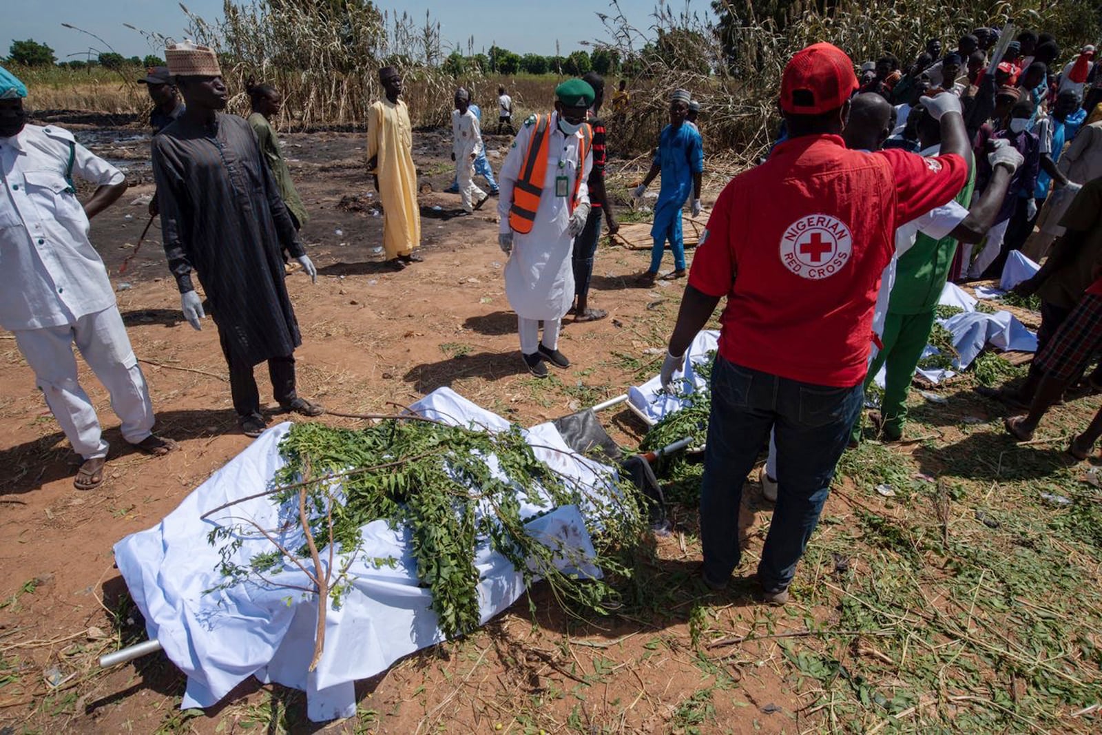 People prepare bodies for burial following a tanker explosion in Majiya town, Nigeria, Wednesday, Oct. 16, 2024. (AP Photo/Sani Maikatanga)