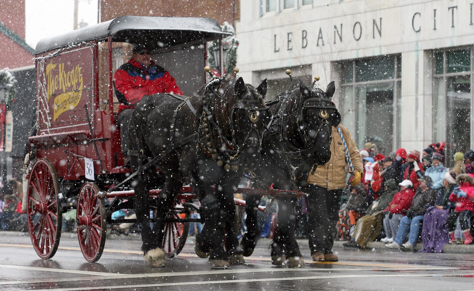 A vintage horse drawn Kroger grocery delivery wagon makes its way past festival goers who line the street to watch the Horse Drawn Carriage Parade during the 2010 Lebanon Historic Christmas Festival.