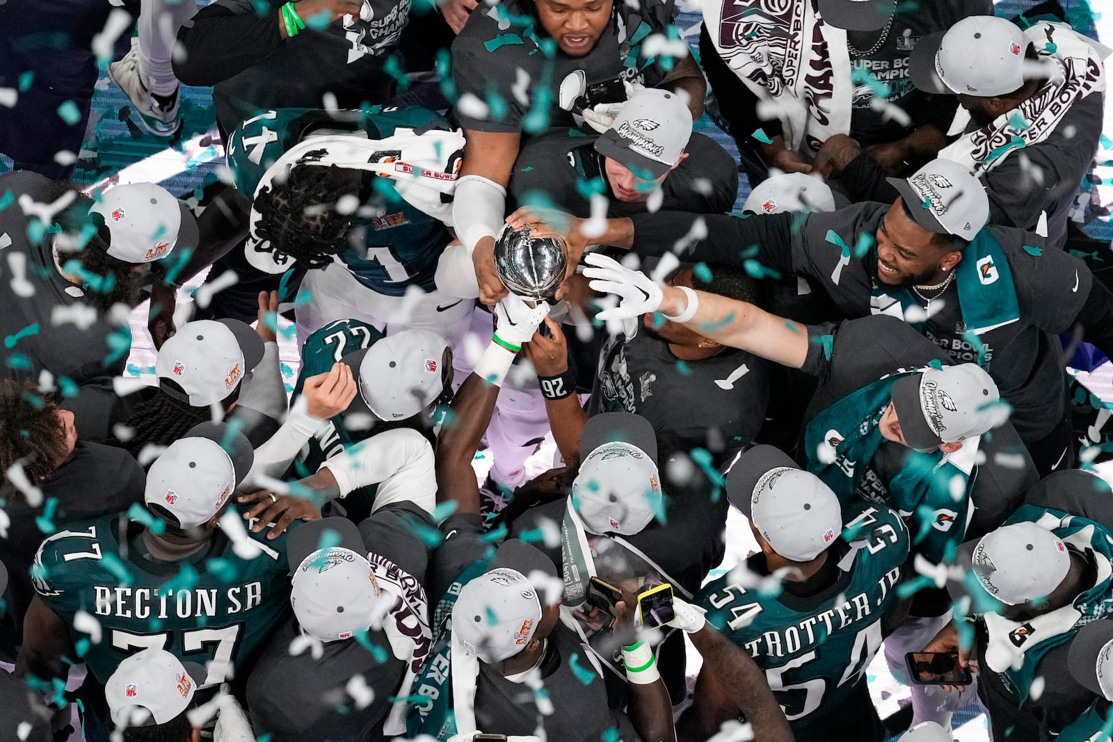 Philadelphia Eagles players celebrate with the Vince Lombardi Trophy after the Eagles won the NFL Super Bowl 59 football game against the Kansas City Chiefs, Sunday, Feb. 9, 2025, in New Orleans. (AP Photo/David J. Phillip)