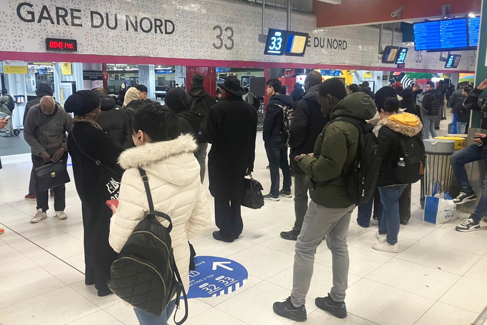 Passengers wait as Eurostar trains to London and all trains heading to northern France have been brought to a halt following the discovery of an unexploded bomb dating back to World War II near the tracks, Friday, March 7, 2025 at the Gare du Nord station in Paris. (AP Photo/Samuel Petrequin)