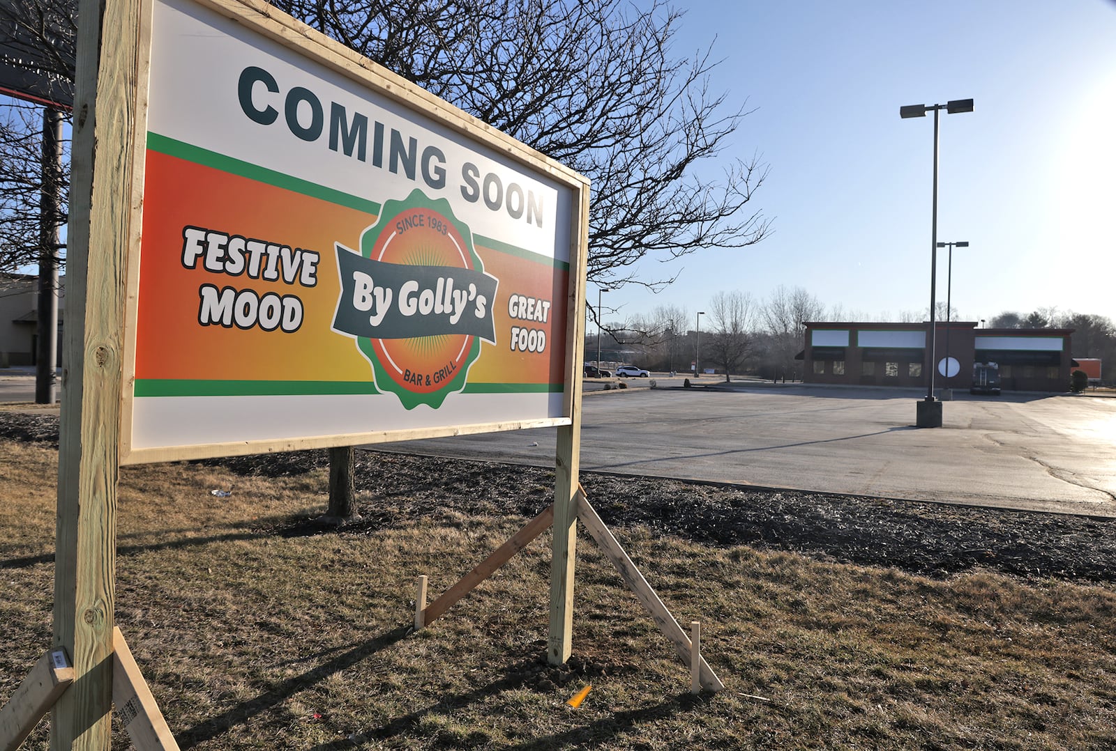 A new sign along Bechtle Avenue announces that a By Golly's restaurant is moving into the former Roosters location Monday, March 10, 2025. BILL LACKEY/STAFF